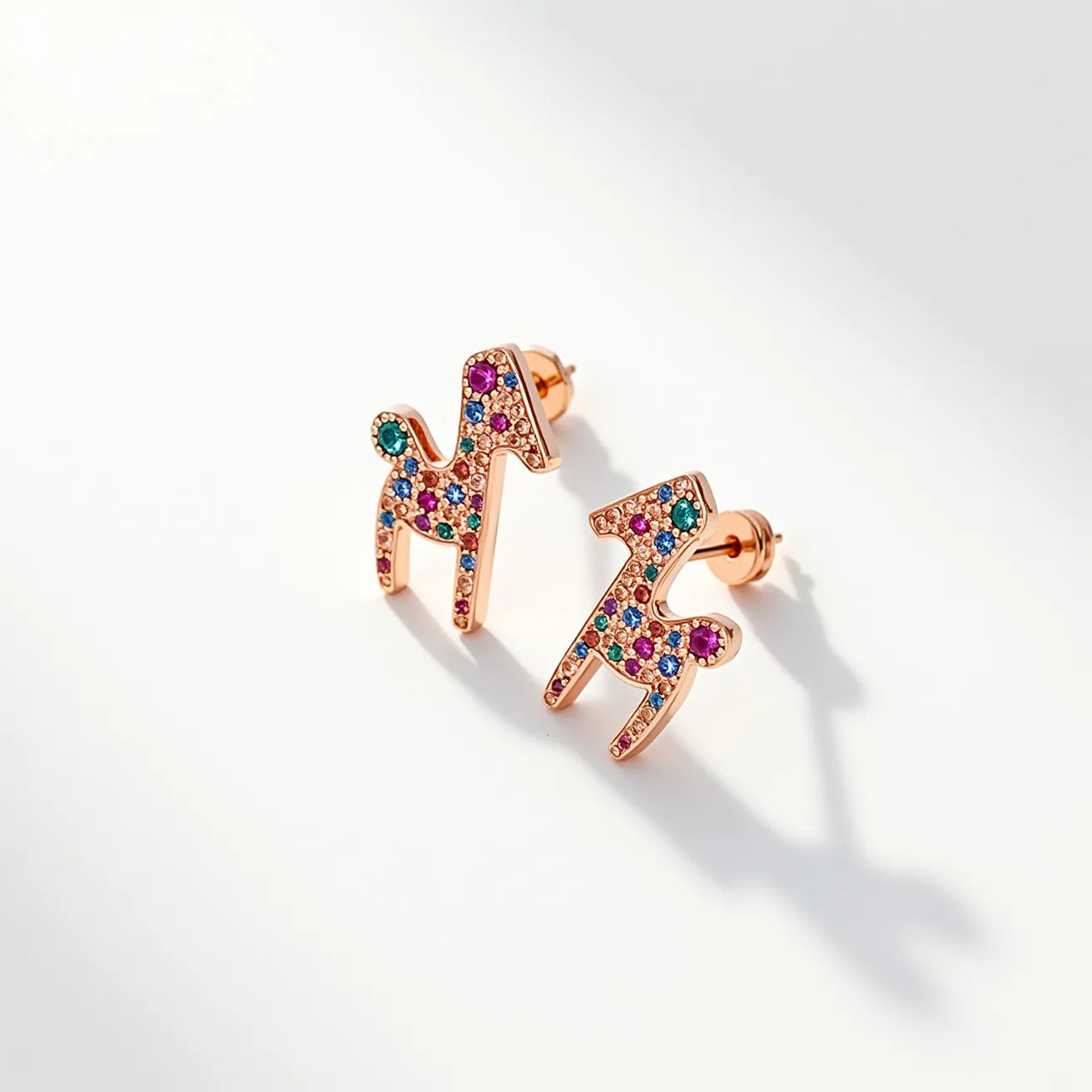 These little girl's earrings are designed in the shape of playful animals, crafted from a shiny metal that resembles rose gold. They are adorned with numerous small, colorful gemstones set in a pavé style, featuring a variety of colors like purple, blue, green, and pink, adding a vibrant and whimsical touch. Each earring is fitted with a typical stud backing, utilizing a butterfly clasp to ensure secure attachment when worn. The design is both fun and elegant, making them suitable for young wearers seeking a touch of sparkle and color.