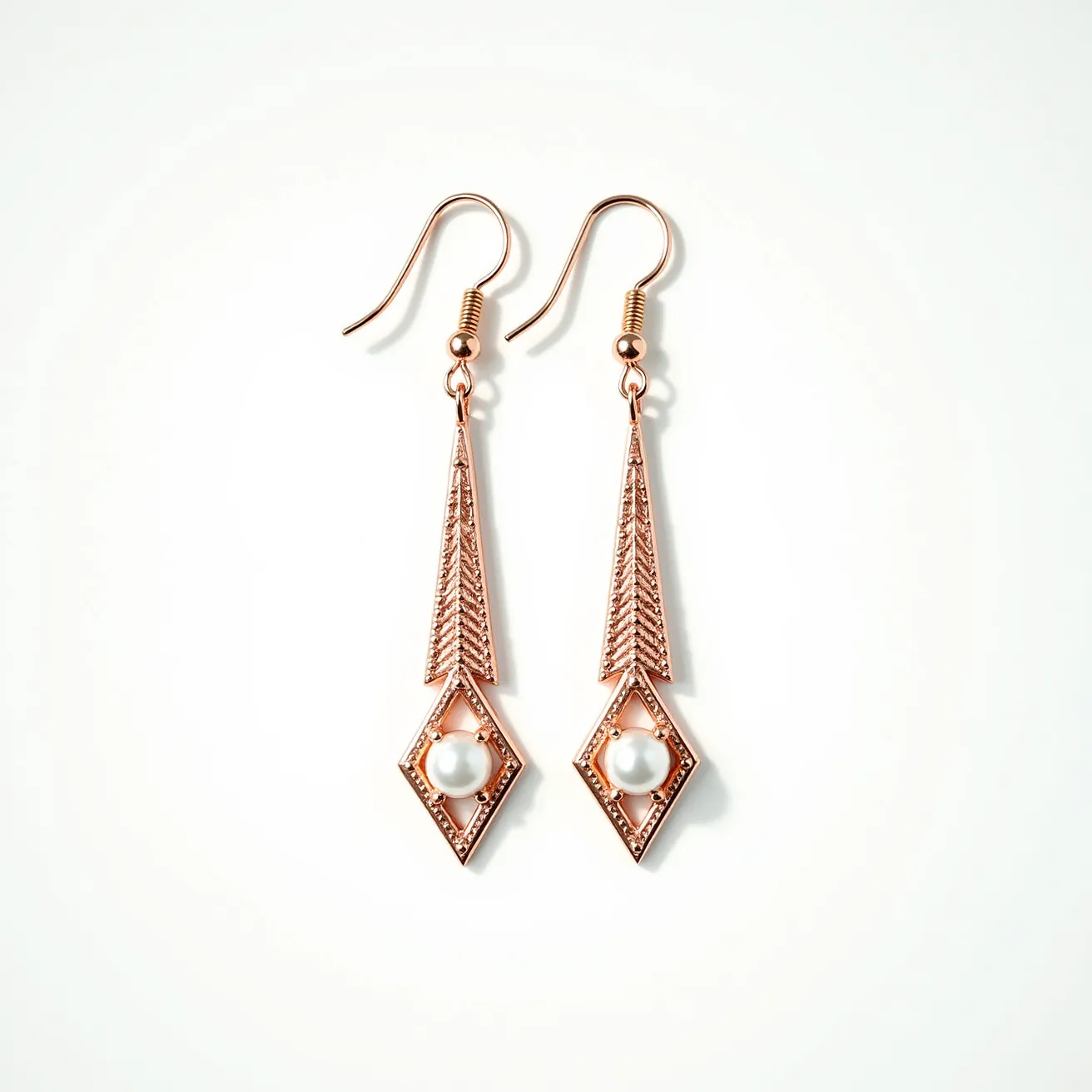 These long earrings feature an elegant design crafted from a rose gold-toned material. The earrings are accented with a pearl-like gem set within a geometric, diamond-shaped frame, which draws attention with its intricate detailing. The pearls have a smooth, rounded shape that adds a touch of sophistication. The earrings are attached with a simple fish hook clasp, offering both security and ease of wear. The overall combination of the rose gold hue and the integrated pearls creates a refined and stylish look.