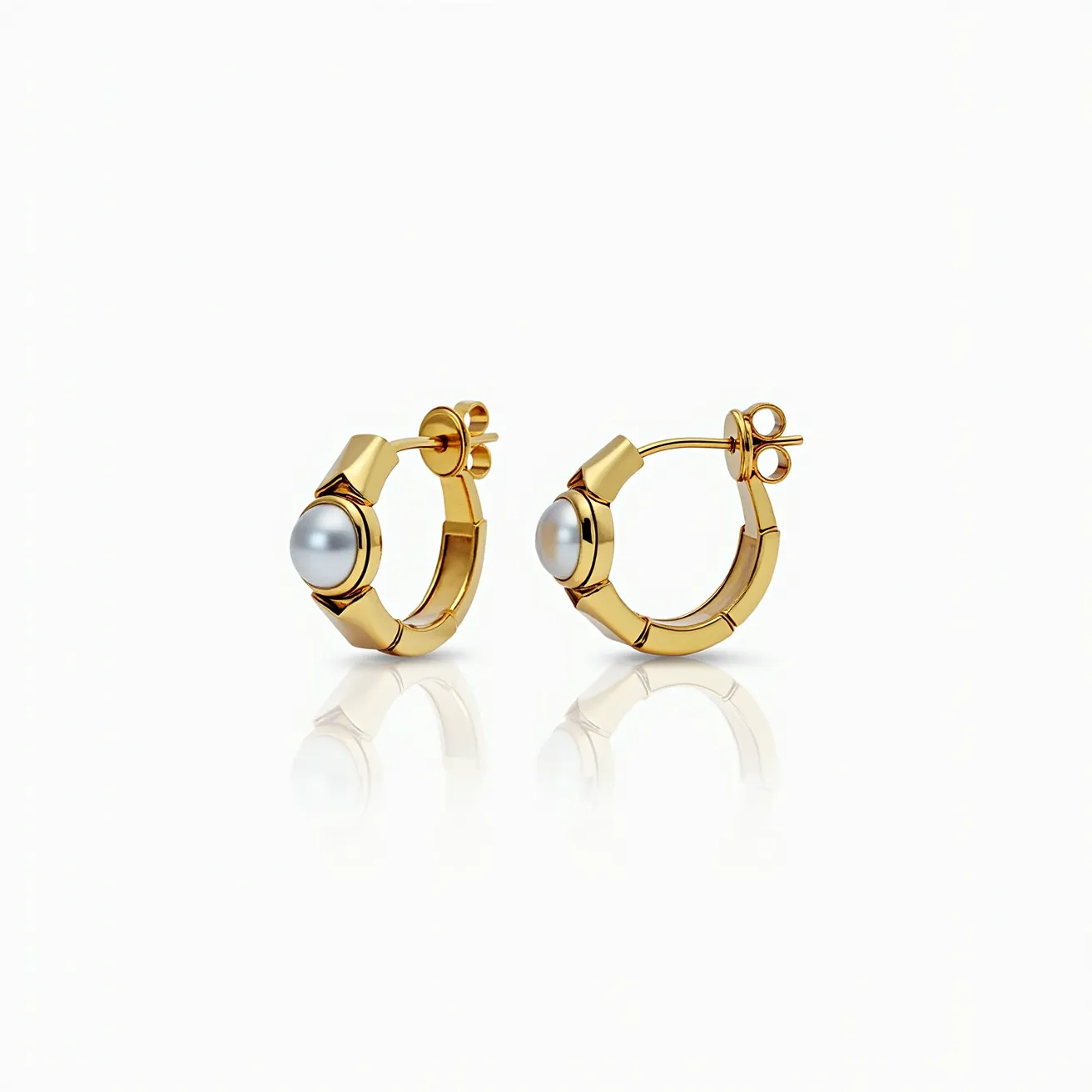 These loop earrings feature a striking design crafted from a polished gold material, showcasing a series of segmented, articulated links that form a continuous circle. At the center of each earring is a luminous pearl, round in shape, set in a smooth bezel that seamlessly integrates into the hoop's structure. The pearl adds an elegant touch with its glossy surface and soft color contrast against the gold. These earrings are secured with a post and butterfly clasp, ensuring a snug and comfortable fit when worn.