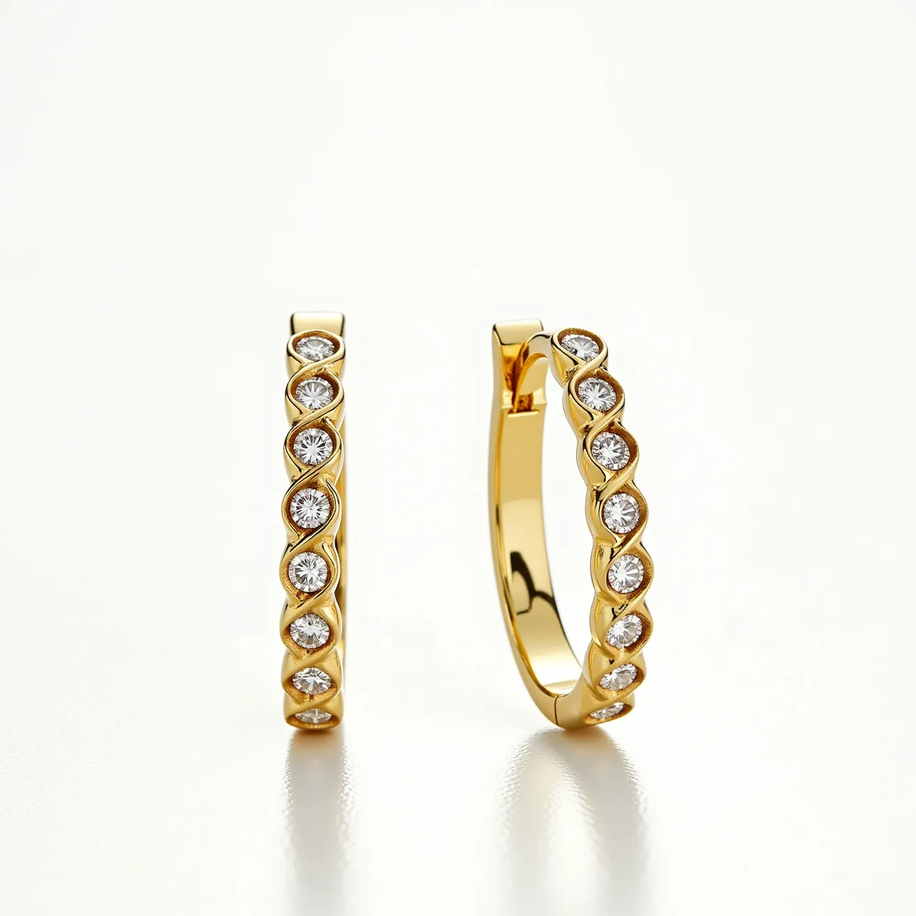 These loop earrings are crafted from a polished gold material, exuding a luxurious shine. They feature a series of round-cut gems, each set meticulously in a bezel setting, ensuring durability and enhancing the overall design. The stones are likely diamonds, given their brilliant sparkle and clarity. The earrings utilize a hinge clasp mechanism, providing a secure and comfortable fit, making them a versatile accessory suitable for various occasions.