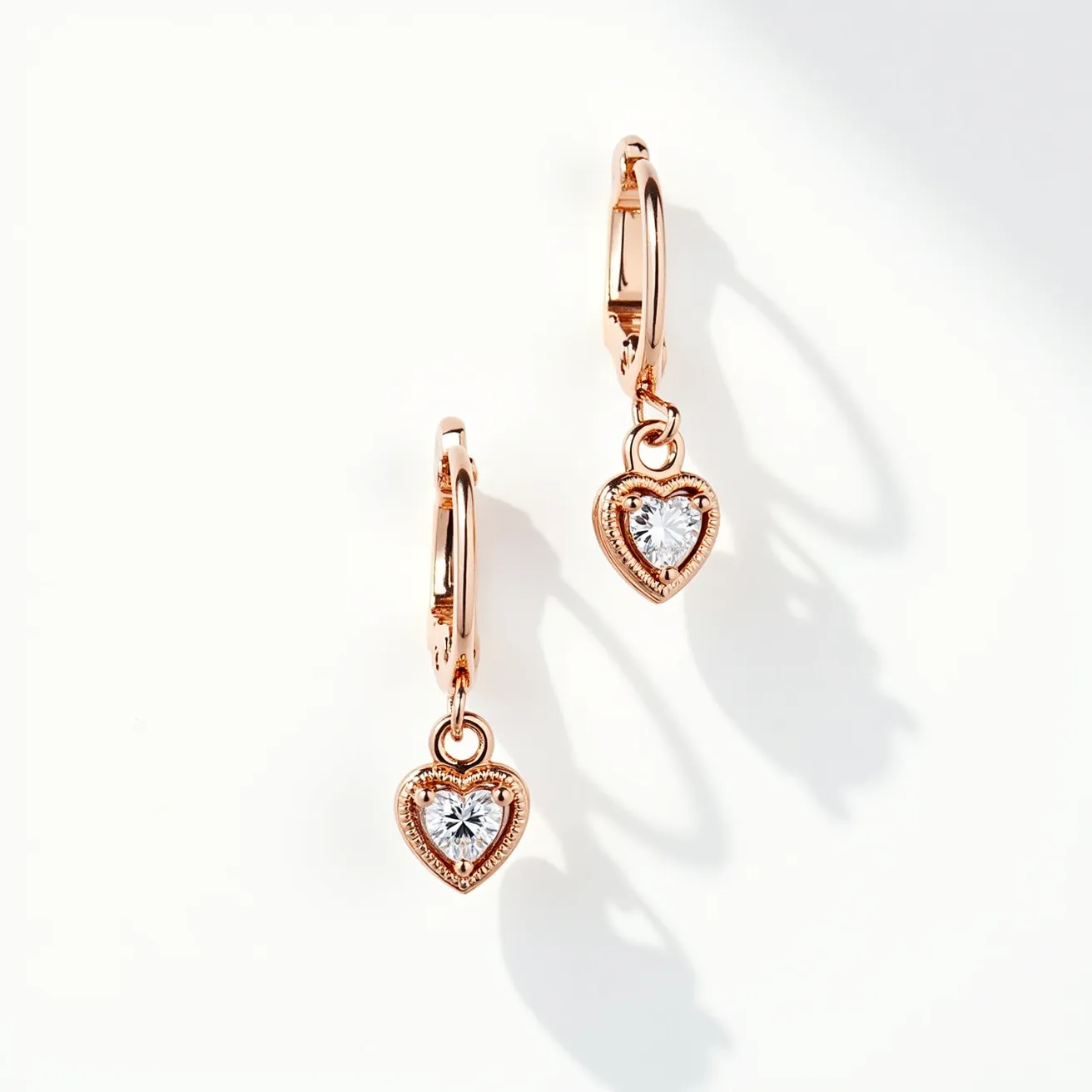 These love earrings are elegantly crafted with a warm gold material that exudes sophistication. Each earring features a heart-shaped setting that beautifully cradles a sparkling gemstone, cut into a brilliant heart shape to enhance its dazzling appearance. The stones are securely held in place by a bezel setting that complements the overall romantic design. The earrings are designed with a hoop clasp, ensuring a secure and comfortable fit for the wearer, while allowing the heart pendants to dangle gracefully. The combination of the gold hue and the shimmering stones creates a timeless and stylish accessory perfect for expressing love and elegance.