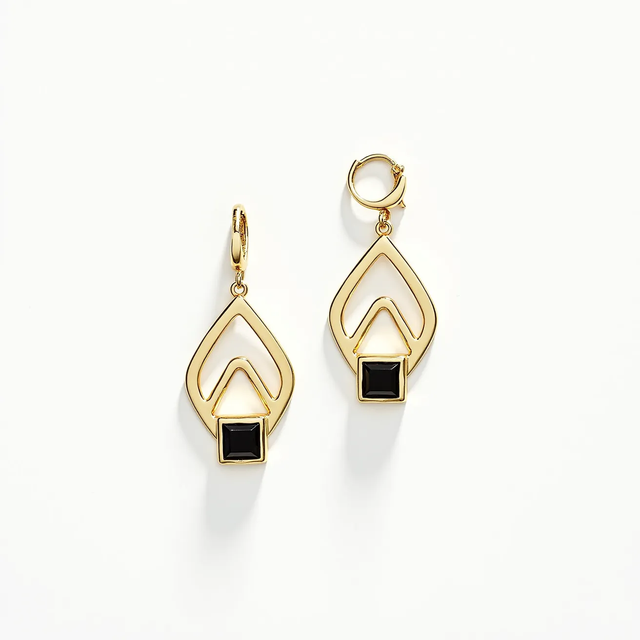 These men's dangle earring features a sleek design primarily crafted from gold-toned metal, forming a geometric pattern that exudes modern sophistication. Each earring showcases a single, square-cut black gem set in a bezel setting at the bottom, providing a striking contrast to the metal's warm hue. The earrings are designed with a latch back clasp, ensuring secure attachment when worn. The overall design combines elegance and a contemporary edge, making it suitable for various occasions.