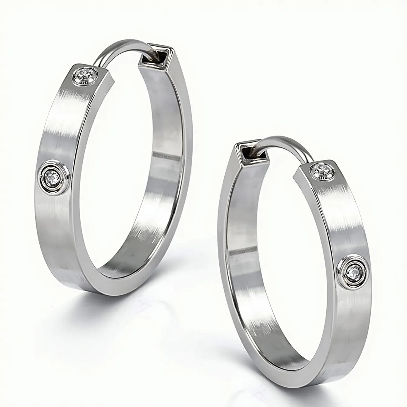 These mens hoop earrings feature a sleek, polished design crafted from stainless steel. Each earring is embellished with a single, round-cut clear gemstone, likely a cubic zirconia, set in a bezel setting that adds a touch of sophistication. The hoops are designed with a hinged clasp mechanism for secure attachment, ensuring both style and functionality. The overall look is modern and minimalist, making it a versatile accessory for various occasions.