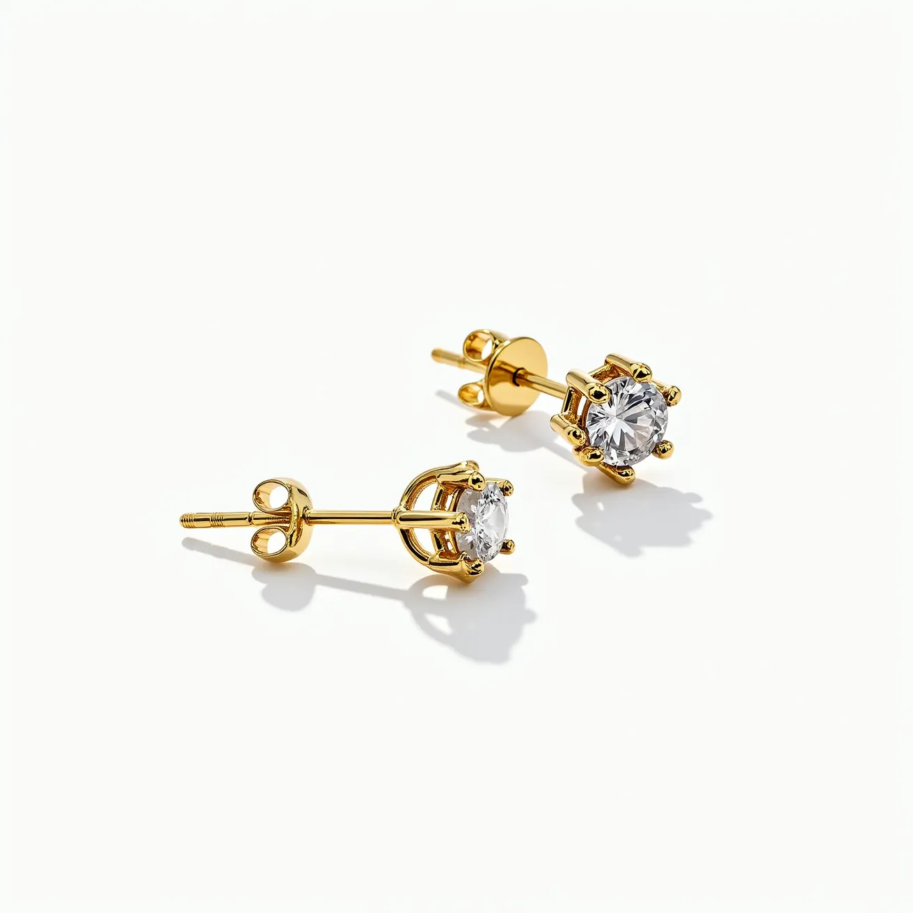 These moissanite earrings feature a pair of round-cut moissanite stones set in a classic prong setting. The prongs and the rest of the earring structure are crafted from a metal with a gold finish, providing an elegant and timeless look. The earrings use a screw-back post for secure attachment, ensuring they stay comfortably in place when worn. The combination of the brilliant moissanite stones and the gold-toned setting makes these earrings both striking and versatile, suitable for various occasions.