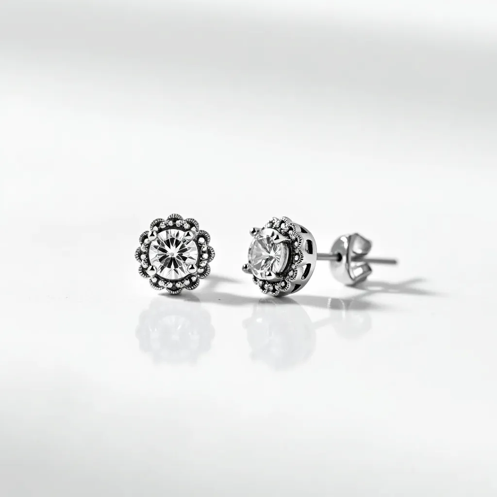 These moissanite earrings feature a central, round-cut moissanite gemstone set in a decorative metal frame with milgrain detailing. The stones are securely held in place by prongs, allowing maximum sparkle. The earrings have a stud/post attachment with a butterfly back, ensuring a secure fit when worn. The metal appears to be polished, possibly white gold or platinum, complementing the brilliance of the moissanite stones. The intricate setting adds an elegant touch to these sophisticated earrings.