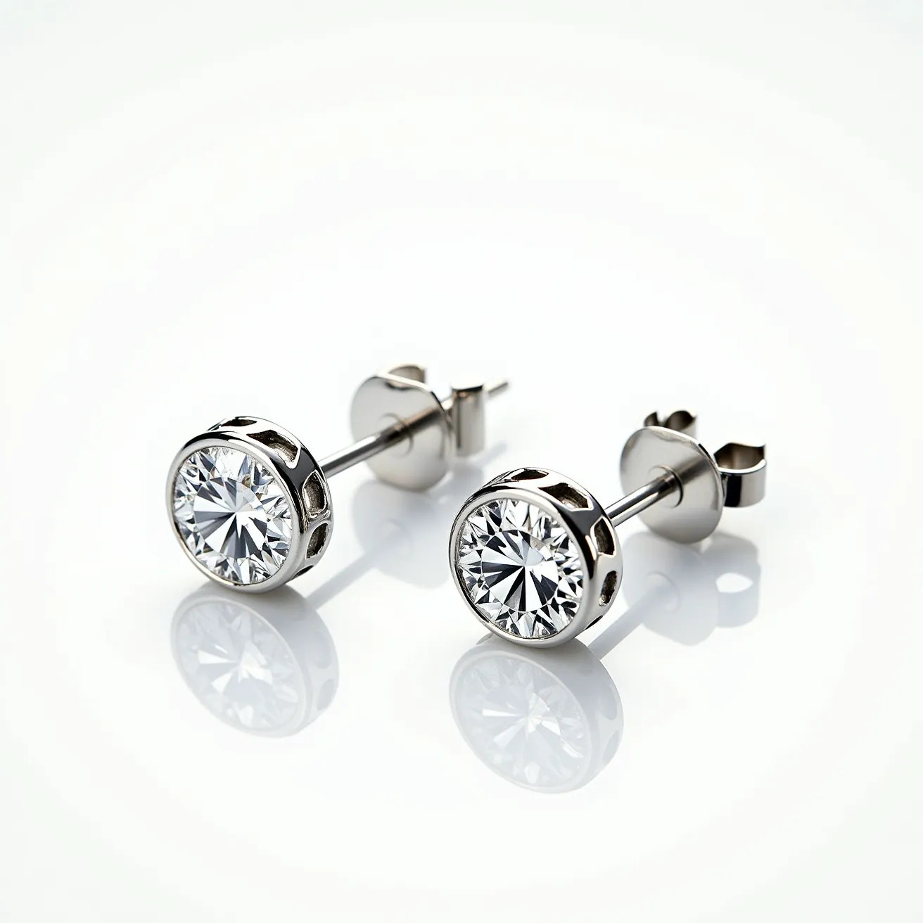 These moissanite earrings feature a round brilliant-cut moissanite gemstone set in a sleek bezel setting, which securely encases the stone while allowing maximum light reflection. The earrings are made of a polished metal, likely white gold or platinum, giving them a sophisticated and modern appearance. The attachment consists of a classic post and butterfly clutch back, ensuring easy wear and a secure fit. The open sides of the bezels add an airy feel to the design, enhancing the brilliance of the moissanite stones while maintaining a contemporary aesthetic.