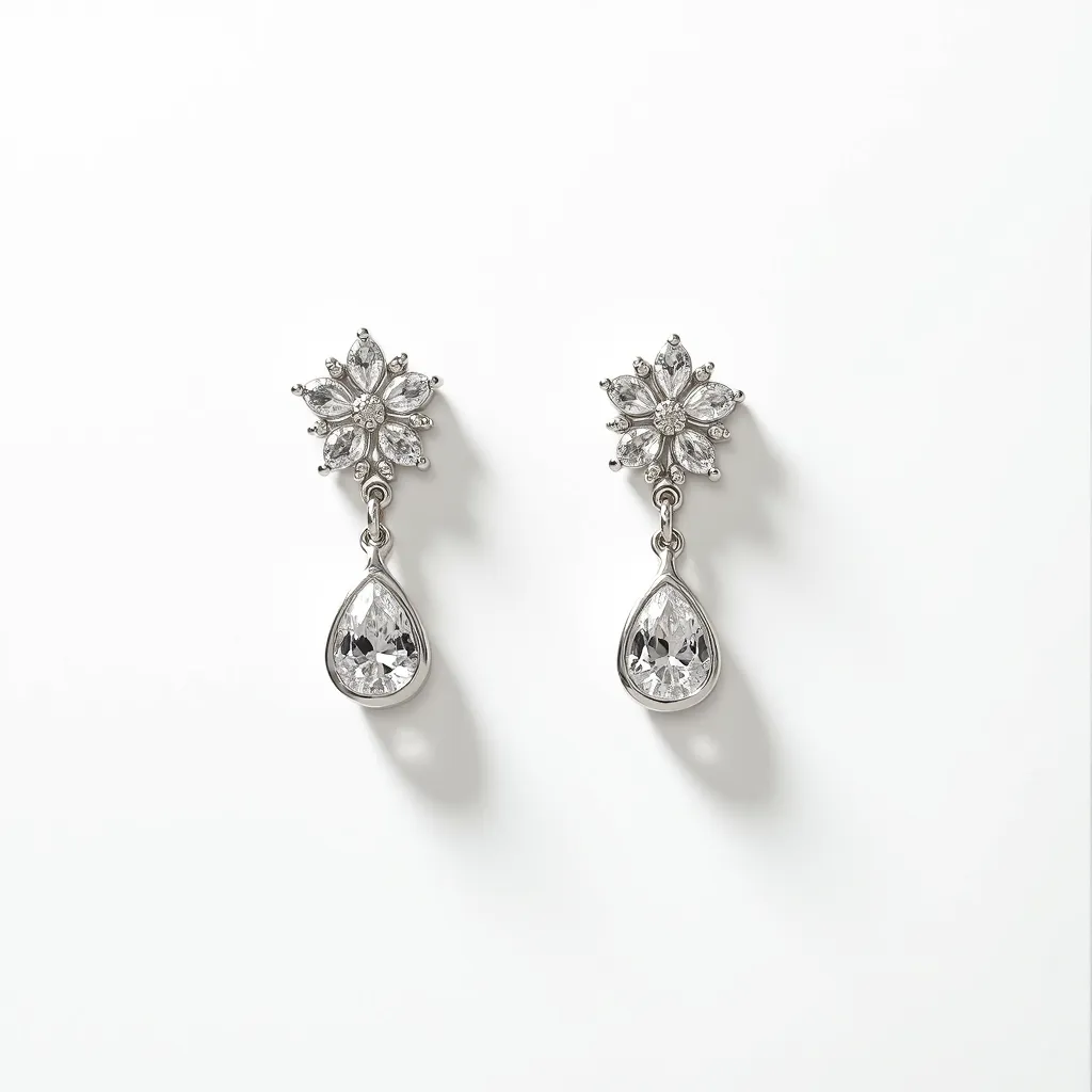 These moissanite earrings feature a stunning combination of materials and design elements. The earrings use moissanite as the primary gemstone, known for its brilliance and fire, set in a classic pear cut that dangles elegantly from each piece. The upper part of the earrings showcases a floral design, crafted with marquise and round-cut stones, adding a delicate touch of sophistication. The gemstones are set in what appears to be a white metal, possibly white gold or platinum, enhancing their reflective quality. These earrings are completed with a post-back closure, ensuring a secure fit.