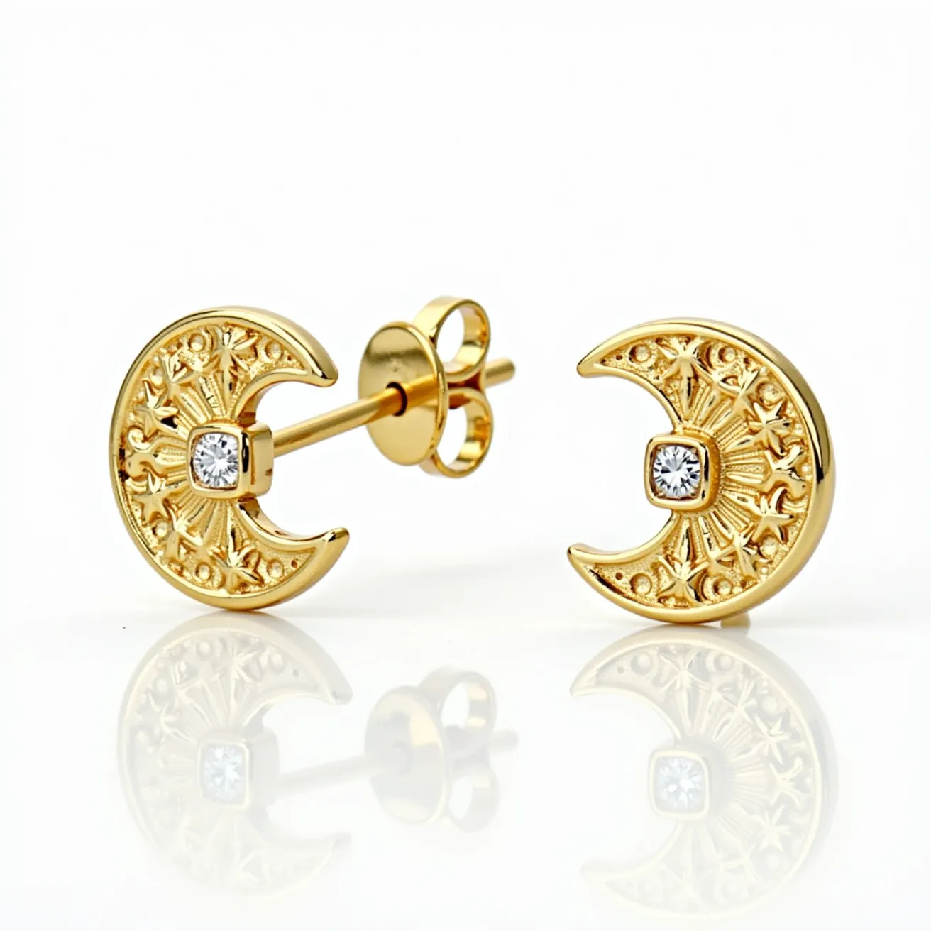 These moon earrings are crafted from a lustrous gold material, featuring an intricate crescent shape adorned with detailed filigree work. At the center of each earring is a single round-cut diamond set in a bezel, adding a touch of sparkle and elegance. The earrings are designed with a classic post and butterfly back clasp, ensuring a secure and comfortable fit for the wearer. The combination of the ornate gold design and the brilliance of the diamonds makes these earrings both unique and sophisticated.