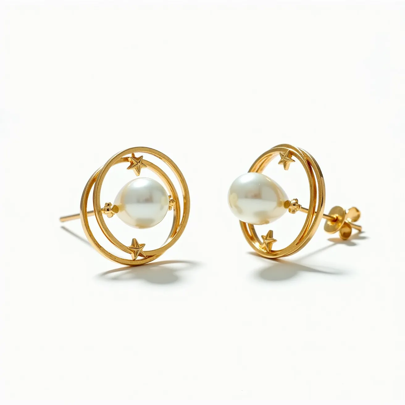 These pearl stud earrings feature a classic design with a central lustrous pearl set within a gold-plated double halo adorned with star motifs. The pearl serves as the focal point, accentuating elegance and simplicity, while the gold-plated setting adds a touch of luxury and sophistication. The earrings are secured with a traditional post and butterfly back fastening, ensuring stability and comfort when worn. The harmonious combination of pearls and gold-plated elements creates a timeless accessory suitable for various occasions.