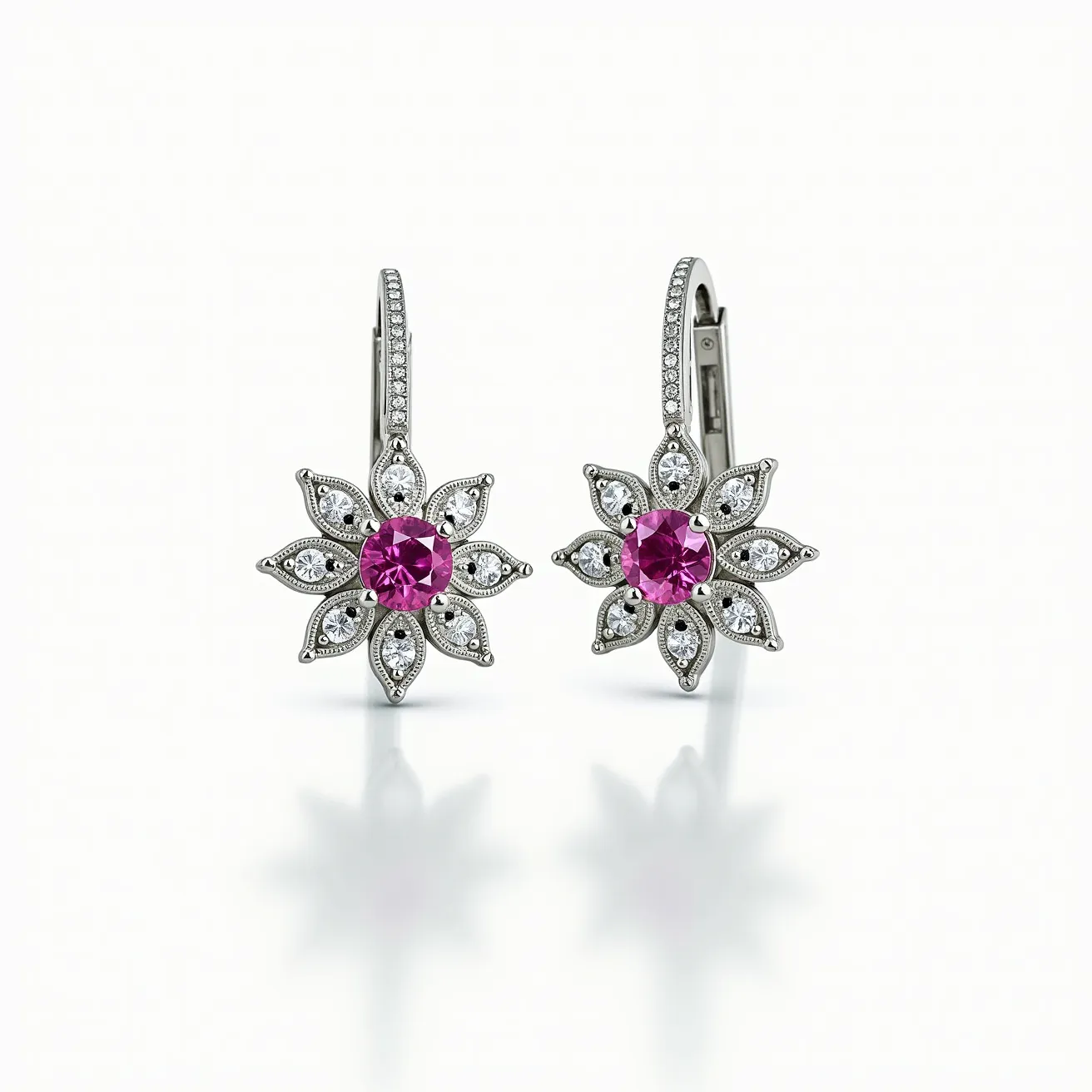 These pink sapphire earrings feature a central round-cut pink sapphire gemstone, surrounded by a floral motif crafted from smaller, white stones—likely diamonds—arranged in a petal-like formation. The setting is delicate, with each smaller stone encased in a metallic border, possibly white gold or platinum, enhancing the sparkle and elegance of the design. The earrings have a lever-back clasp attachment, which provides both security and ease of wear. The overall effect combines a classic and sophisticated aesthetic, with the vibrant pink sapphire as the focal point.