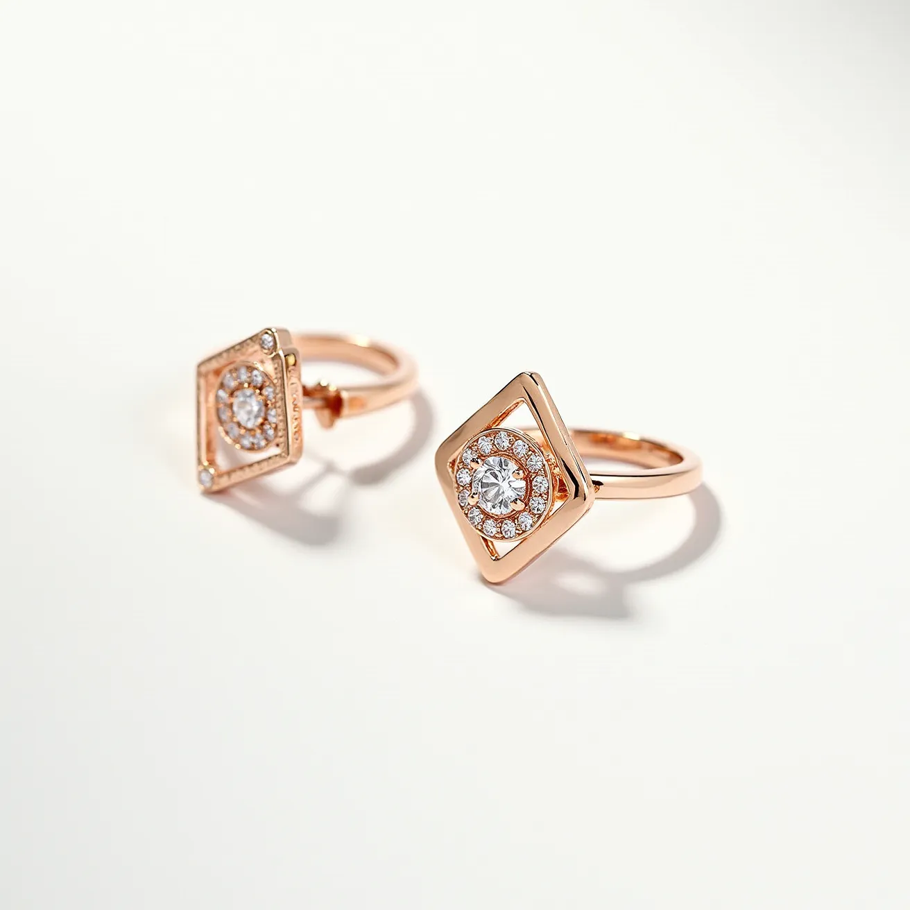 These ring earrings feature a striking design with a square frame crafted from a warm, possibly rose gold metal. At the center of each earring is a large round-cut gemstone, likely a diamond or a high-quality crystal, set in a secure prong setting. Surrounding this central gem is a halo of smaller round-cut stones, each carefully arranged to enhance the overall brilliance of the piece. The earrings are attached with a post-and-back system, ensuring a secure fit when worn. These elegant earrings combine classic and contemporary elements, making them a versatile accessory.