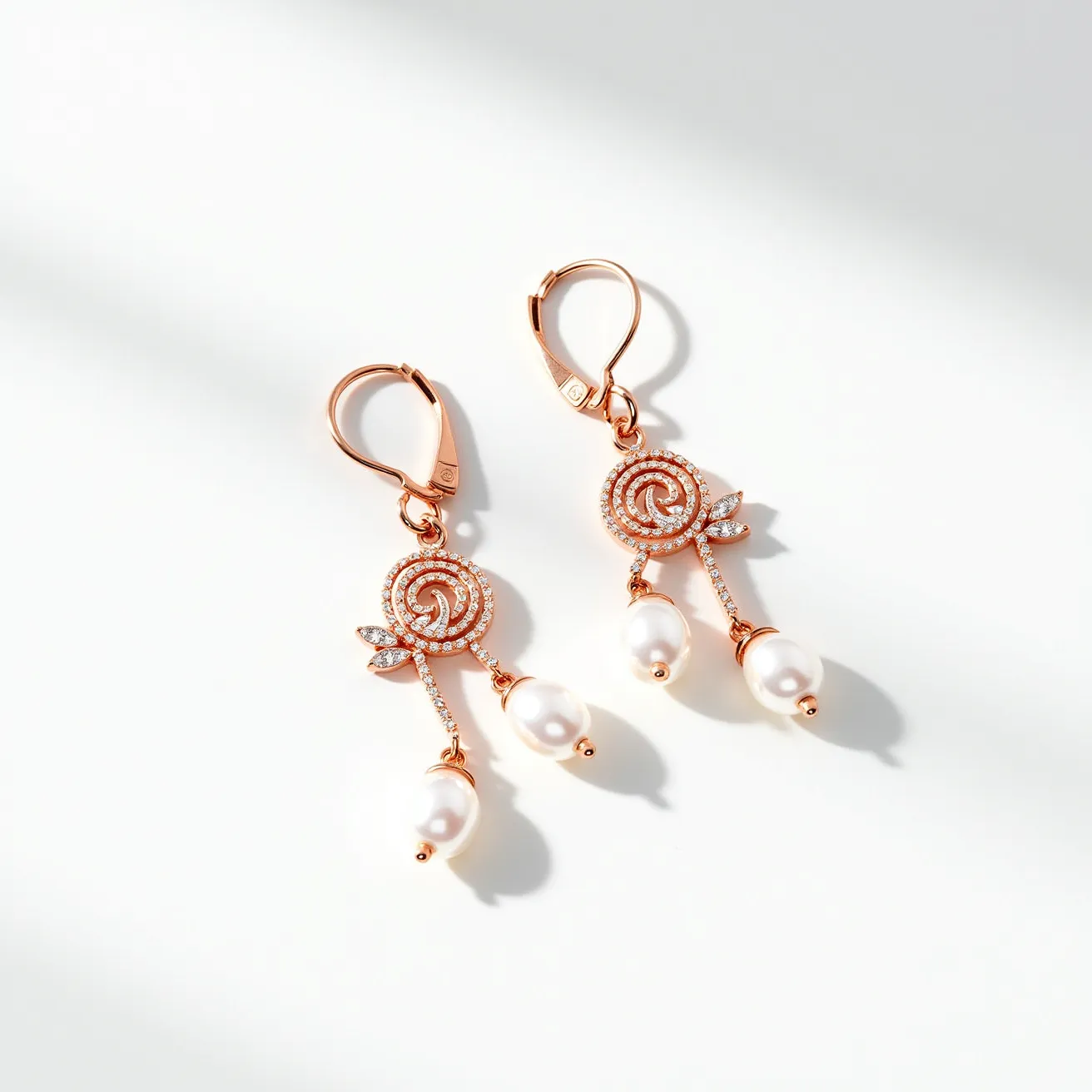 These rose earrings are crafted with a rose gold metal that forms a spiral design resembling a rose. Small, round-cut clear stones are embedded in the spiral, enhancing its elegance and adding a touch of sparkle. The earrings feature a leaf motif adorned with similar round-cut stones, adding to the intricate design. Dangling from each earring are two teardrop-shaped pearls, providing a classic and sophisticated finish. The earrings are secured with lever-back clasps, ensuring a secure attachment and comfortable wear.