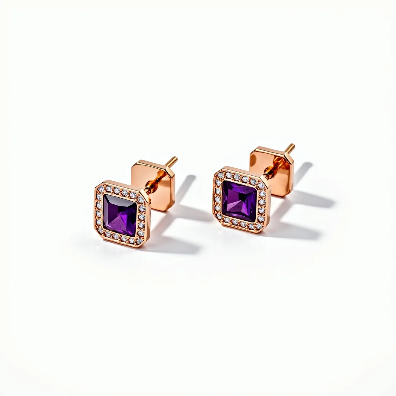 These square earrings feature a central purple gemstone with a square cut, encased in a rose gold setting. The perimeter of the earrings is adorned with small, round clear stones, possibly diamonds, creating an elegant halo effect around the central stone. The gold tone of the setting provides a warm contrast to the cool purple of the central gem. These earrings are attached with a simple post and butterfly clutch back, ensuring secure wear while maintaining a sleek and polished appearance.