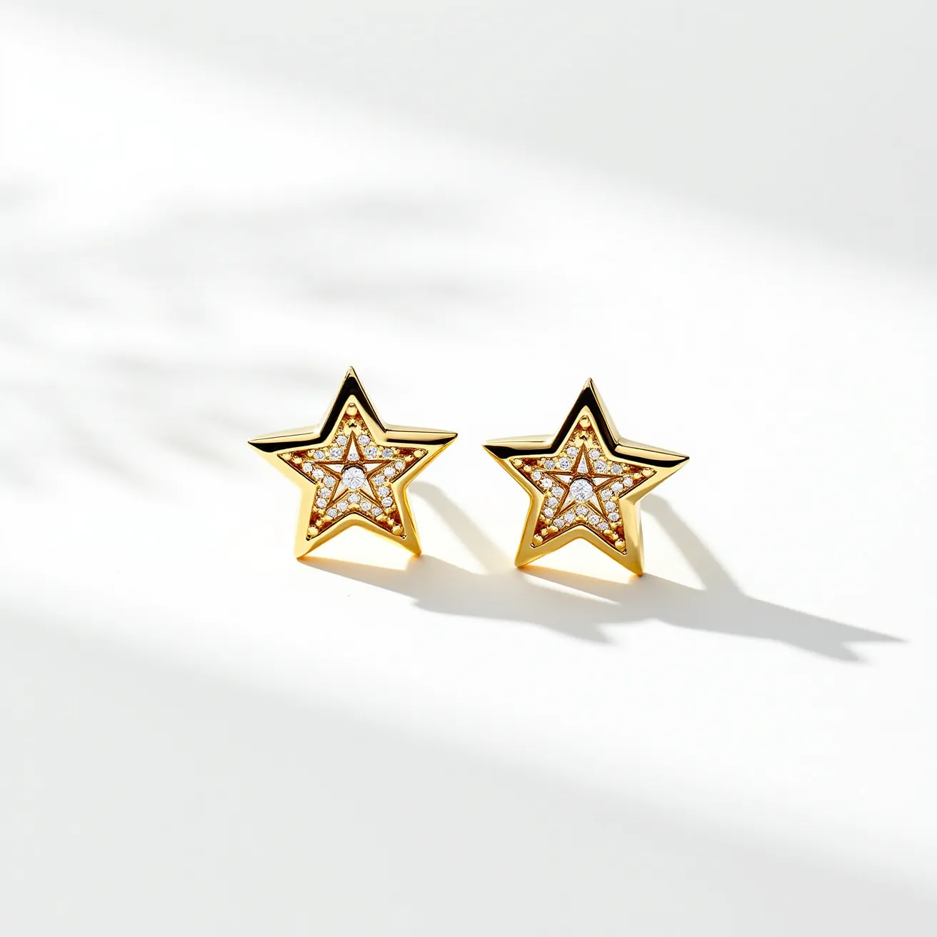 These star stud earrings feature a captivating design with a gold-toned metal forming the star shape. The interior of the star is adorned with small, round-cut clear gemstones, likely cubic zirconia or diamonds, arranged in a pavé setting that adds a touch of sparkle and elegance. The smooth and polished outer edges enhance the contrast with the shimmering stones inside. The earrings are designed as studs, suggesting a simple post likely secured with a butterfly clasp, ensuring a secure and comfortable fit. The combination of the gold tone and the sparkling stones gives these earrings a stylish and classy appeal, making them suitable for various occasions.