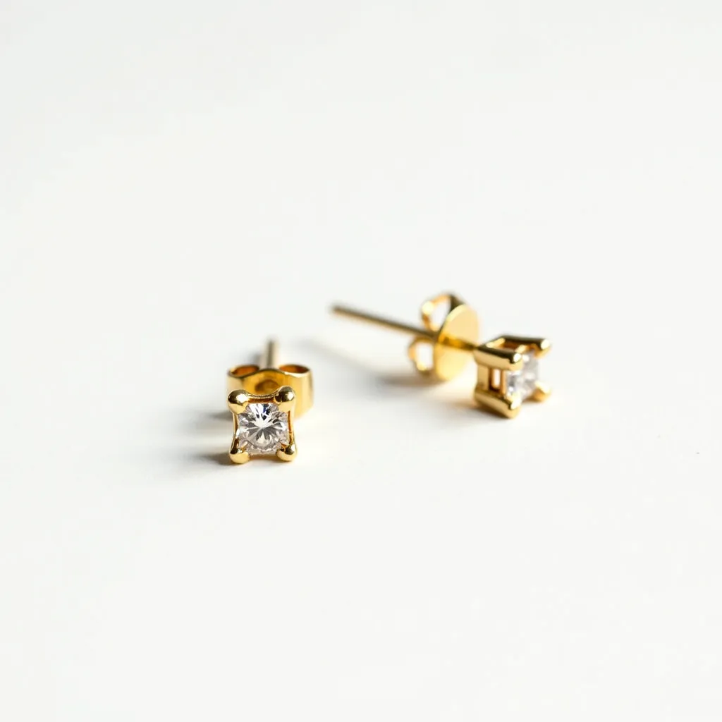 These stud earrings feature a classic design crafted from a gold-toned metal, adding a touch of elegance. Each earring is set with a single round-cut gemstone, likely a diamond or a diamond simulant, securely held in a four-prong setting that enhances its brilliance and ensures stability. The earrings are equipped with a standard post and butterfly clutch back, providing ease of use and secure attachment when worn. These elements together create a timeless and versatile accessory suitable for various occasions.