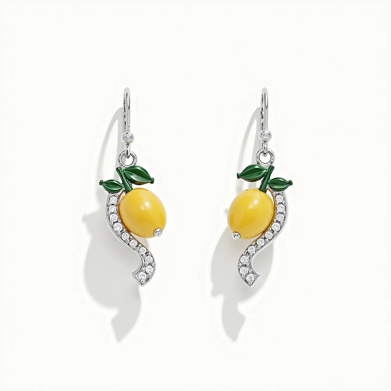 These teacher earrings feature a charming design with a lemon motif. The lemons are crafted from a vibrant yellow material, likely resin or enamel, giving them a bright and cheerful appearance. They are complemented by green leaf accents, adding a natural touch. The earrings are adorned with small, clear, round-cut stones set in a curving pattern, which may be rhinestones or cubic zirconia, enhancing their sparkle. The design is anchored on a metallic base that appears to be silver-toned, possibly plated or polished. The earrings are affixed with a simple hook clasp, allowing for easy wear and removal.