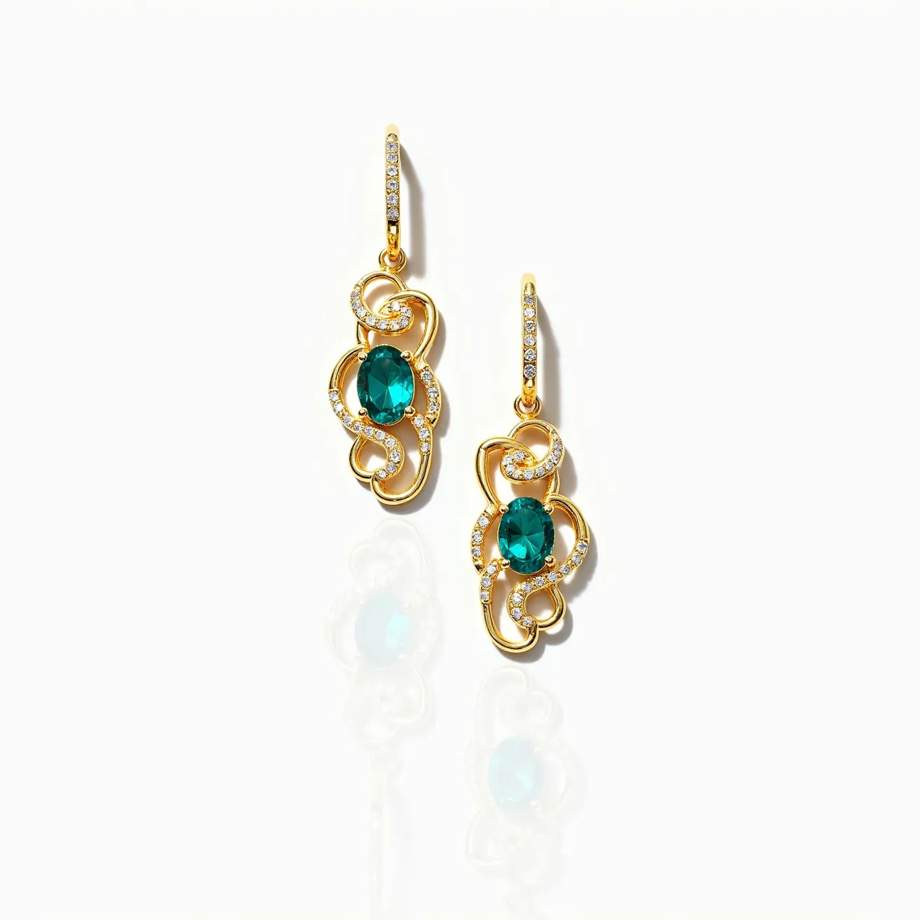 These teal earrings feature elegant gold settings adorned with intricate swirl patterns. At the center of each earring is an oval-cut teal gemstone, providing a vibrant focal point. Surrounding these central stones are small, clear gemstones, likely diamonds, set meticulously along the curves to enhance their brilliance and capture light beautifully. The earrings attach via a gold hook clasp, which is also accented with small, sparkling stones, ensuring both security and style. The combination of gold, teal gemstones, and sparkling accents creates a luxurious and eye-catching look.