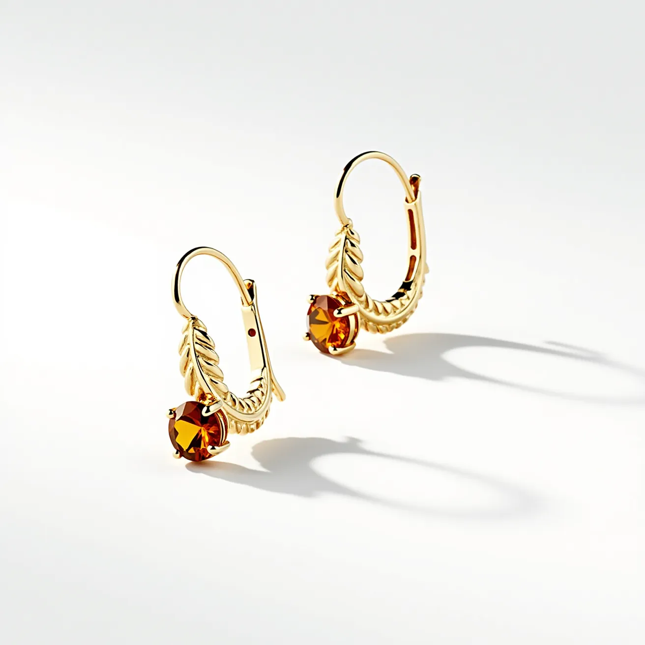 These thanksgiving earrings feature a warm, autumnal design with gold-toned metal as the primary material. Each earring includes a round, faceted gemstone of a deep amber hue, suggesting a gemstone like citrine or topaz, securely set in a prong setting. The earrings are adorned with a decorative leaf motif on the hoop, adding to their festive and seasonal appeal. The attachment style includes a hinged clasp for secure wear, ensuring they stay comfortably in place while adding a touch of elegance to any Thanksgiving ensemble.