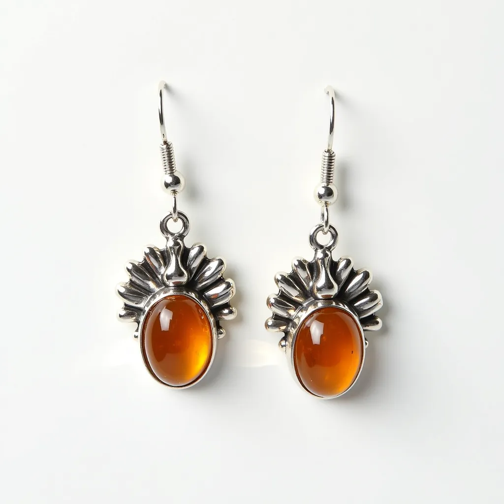 These Thanksgiving earrings feature an elegant design with a vibrant amber-colored oval cabochon stone set securely in a polished silver-toned metal base. The stones are prominently displayed, drawing attention with their rich, warm hue reminiscent of autumn leaves. Surrounding the oval stones is a stylized silver metal fan resembling a Thanksgiving turkey's tail, adding a festive touch to the overall design. The earrings are equipped with a classic fish hook clasp, allowing for easy and comfortable wear. The harmonious combination of the amber stones with the detailed silver setting makes these earrings a perfect accessory for Thanksgiving celebrations.