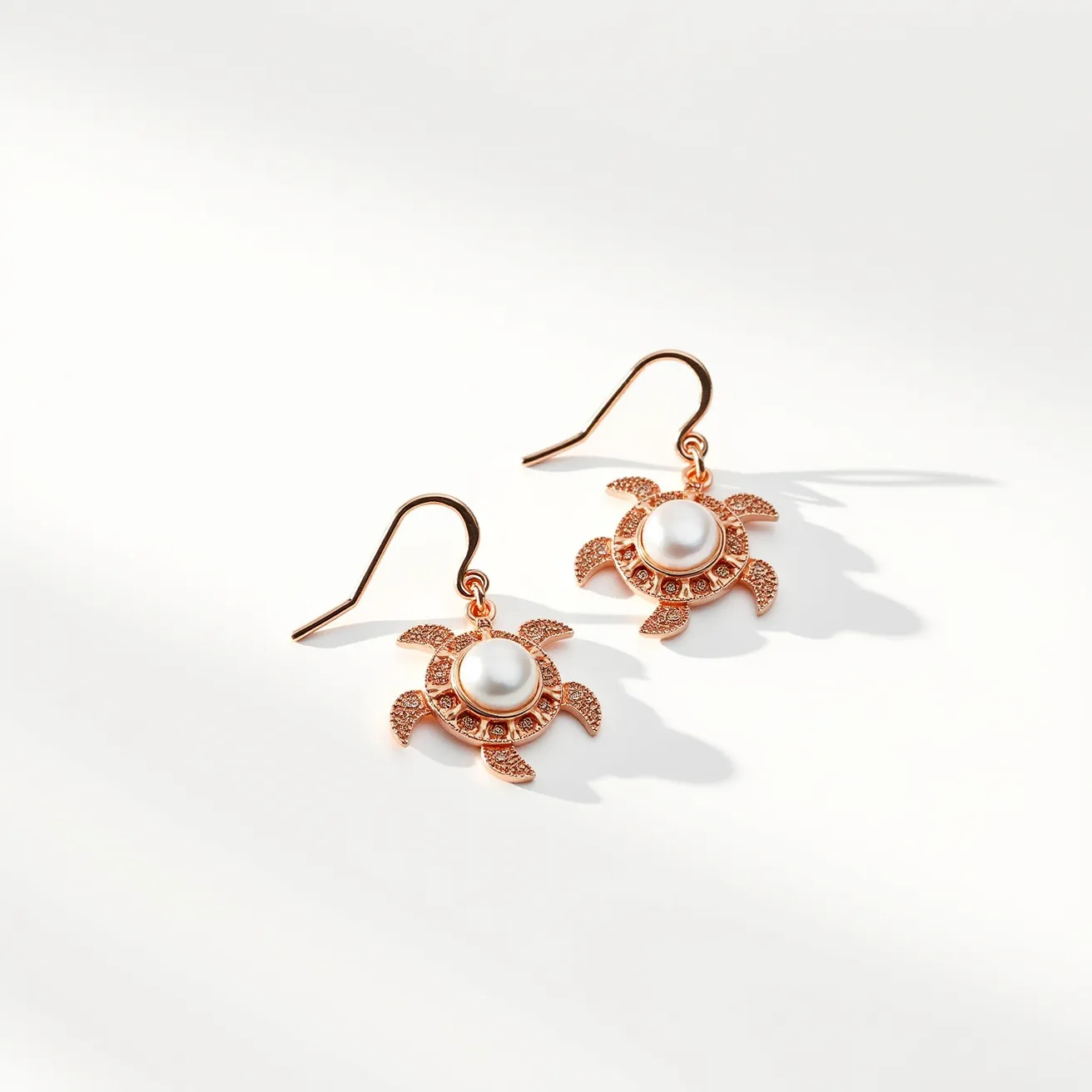 These turtle earrings feature a charming design crafted from a copper-toned metal that forms the distinct shape of a sea turtle. Each earring highlights a prominent, smooth pearl at the center, adding a touch of elegance and sophistication to the playful design. The earrings utilize a fishhook clasp for attachment, ensuring easy wear and a secure fit. The turtles' detailed flippers and shells contain delicate embellishments that enhance their intricate appearance. The combination of materials and design elements in these turtle earrings creates an appealing accessory suitable for various occasions.