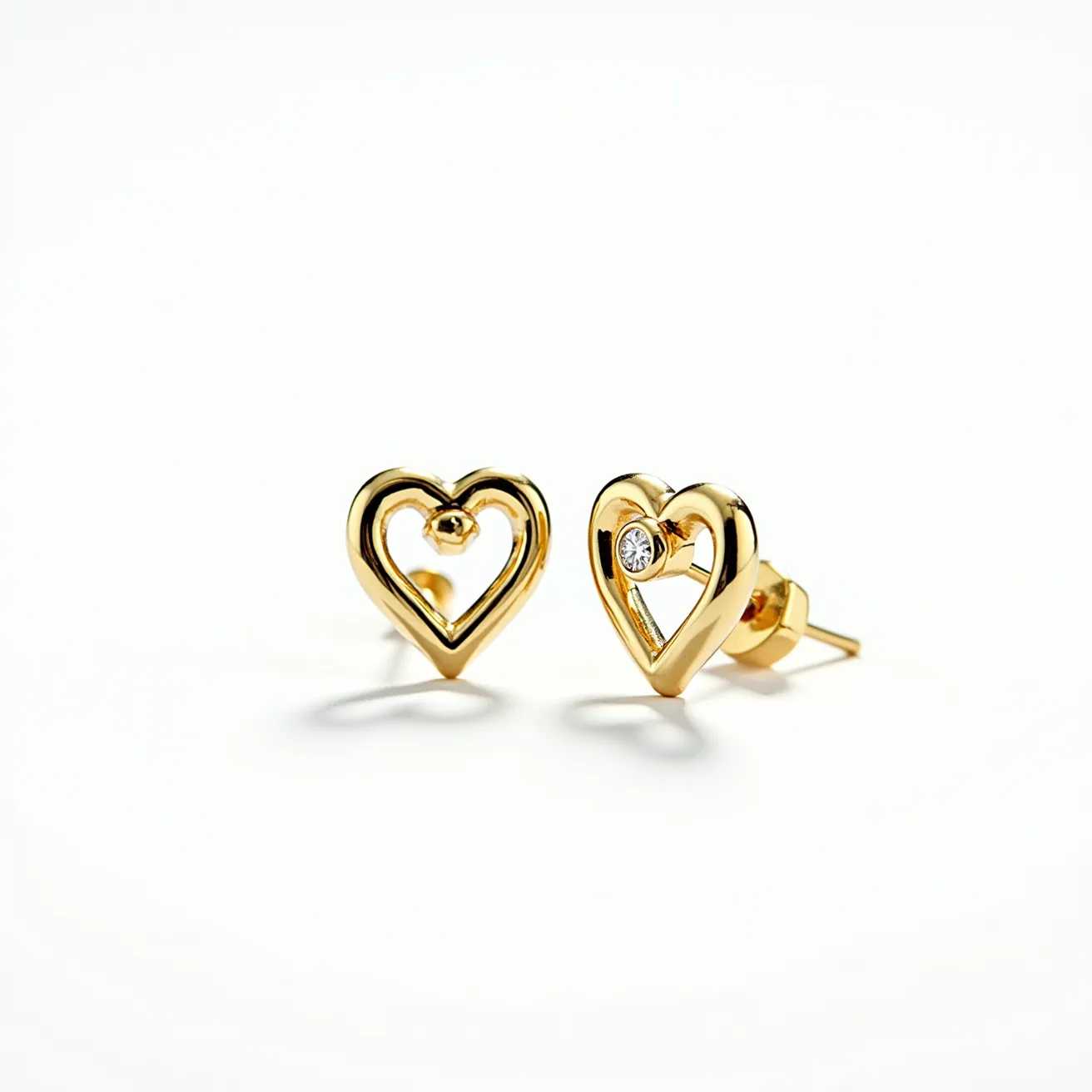 These Valentine's earrings feature an elegant heart-shaped design crafted from a polished gold material, exuding a romantic and timeless aesthetic. Each earring is adorned with a single, round-cut diamond set at the center, adding a touch of sparkle and sophistication. The stones are securely held in place with a bezel setting, ensuring both visibility and protection. These earrings are equipped with a classic stud post and butterfly back clasp, providing secure and comfortable wear.