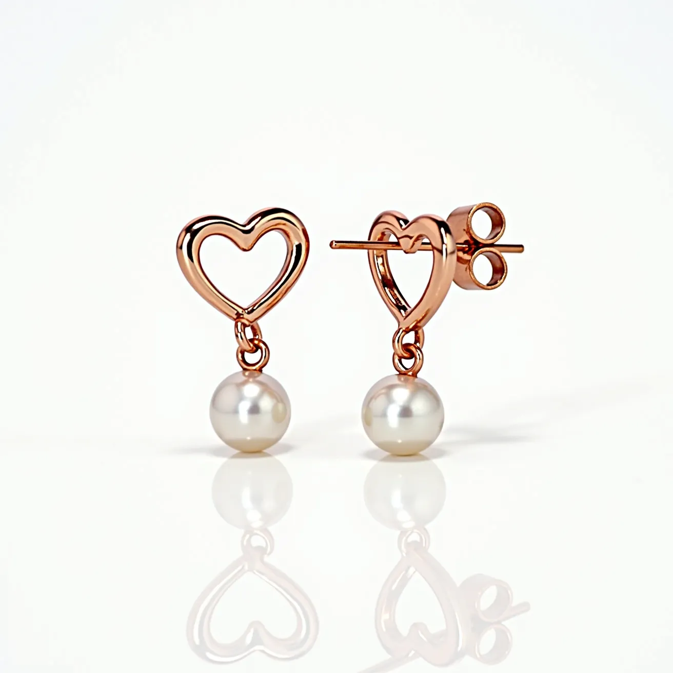 These valentines earrings feature lustrous pearls that dangle elegantly from heart-shaped frames crafted from rose gold-toned metal. The pearls are smooth and spherical, suggesting a classic and timeless appeal. The heart shapes are open and delicately outlined, adding a romantic touch that aligns with a Valentine's theme. The earrings are secured with a post-back clasp, which provides a secure and comfortable fit for the wearer. This combination of rose gold and shimmering pearls creates a sophisticated yet playful design.
