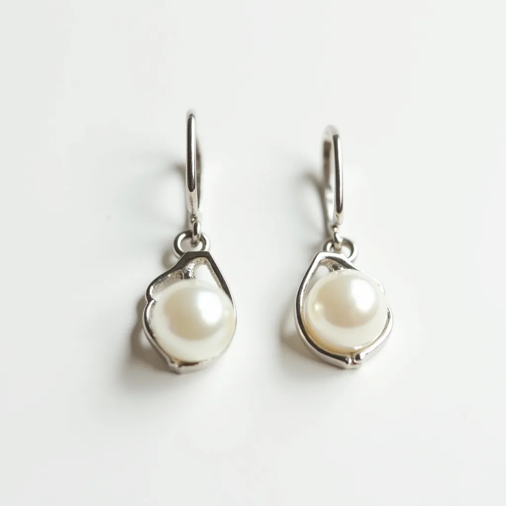 These white earrings feature a delicate design with lustrous pearls serving as the focal point. The pearls are set within a simple, smooth metal setting, likely silver, which elegantly frames each pearl, adding a subtle shine. The earrings have a secure lever-back clasp, providing ease of wear while keeping the earrings securely fastened. The combination of the pearls and the understated metal setting creates a classic and sophisticated aesthetic.