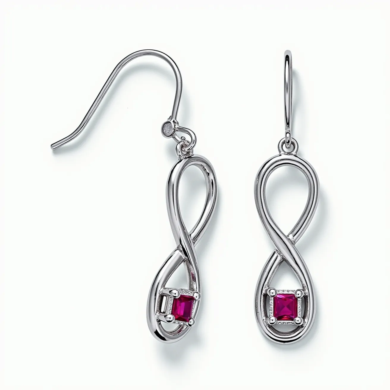 These white earrings feature an elegant infinity loop design, crafted from a polished metal that appears to be silver or white gold. At the center of each earring lies a square-cut red gemstone, likely a ruby, securely held in a four-prong setting. The stones add a vibrant contrast to the sleek structure of the earrings. The earrings are equipped with a French hook clasp, offering a simple yet secure attachment method. The overall design blends fluid curves with a touch of color, creating a sophisticated and timeless accessory.