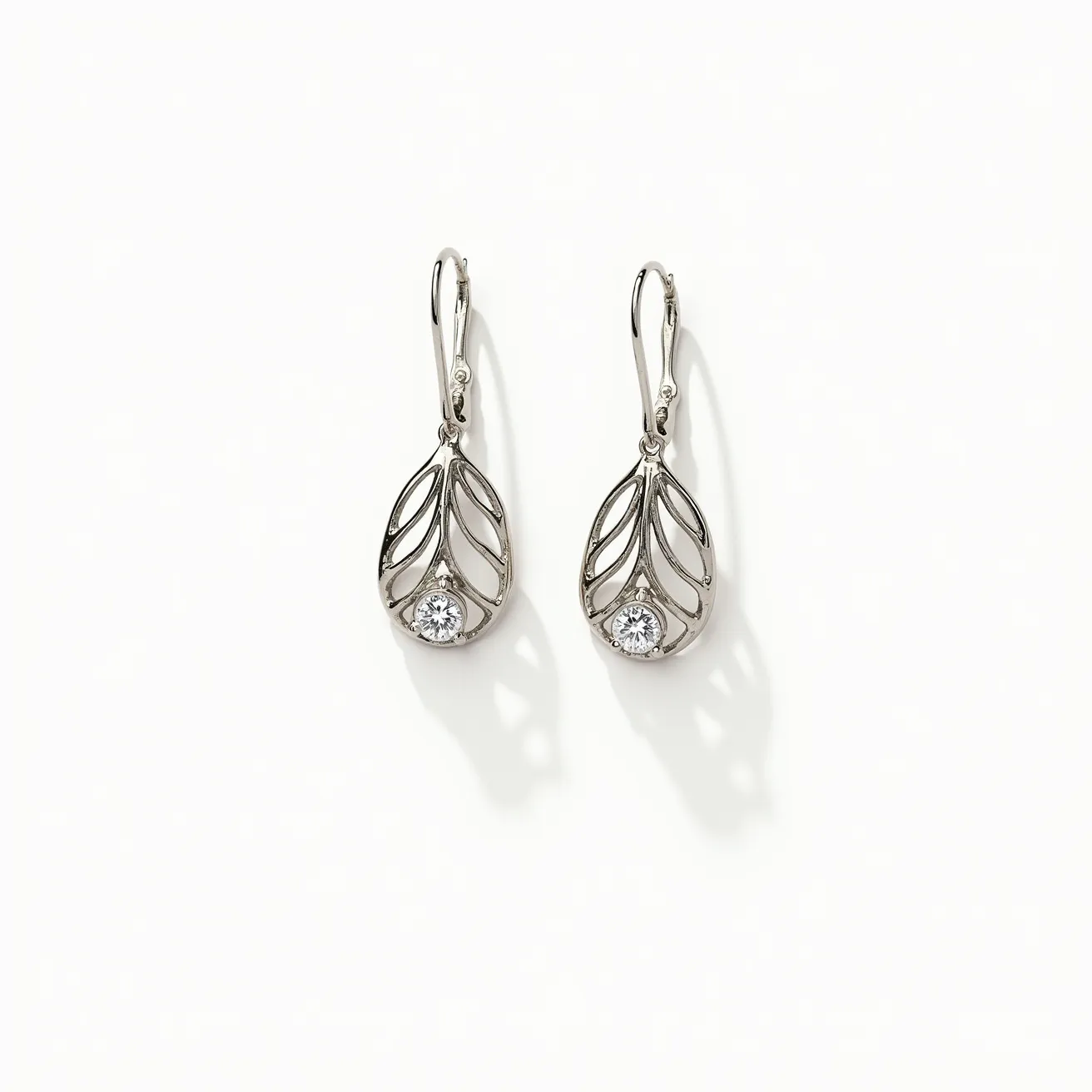 These white gold earrings feature an intricate openwork leaf design, beautifully accentuated with a single round-cut diamond set at the base of each earring. The diamonds are securely held in place by a prong setting, which allows them to catch and reflect light, adding a touch of elegance and sparkle. The earrings are designed with a lever-back clasp, ensuring a secure and comfortable fit for the wearer while also maintaining the piece’s graceful aesthetic. The craftsmanship and material selection underscore the earrings' luxurious appeal, making them a timeless accessory.