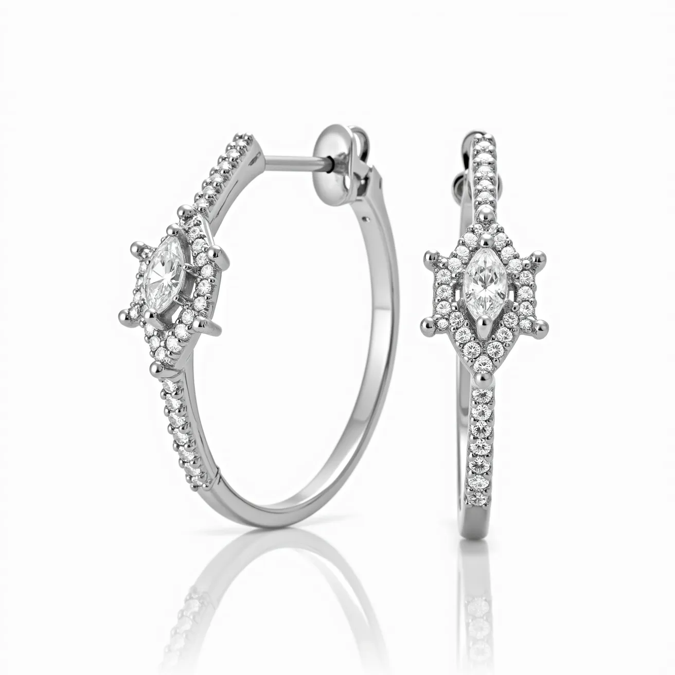 These white gold earrings feature a sophisticated design with a hoop structure embellished with small, round-cut diamonds set into the metal. At the focal point of each earring is a prominent marquise-cut diamond, surrounded by a halo of smaller round diamonds, adding to the elegance and sparkle. The diamonds are securely set in prongs, ensuring both security and maximum exposure to light. These earrings are designed with a hinge clasp mechanism, providing a secure and comfortable fit for the wearer. The combination of high-quality materials and precise craftsmanship makes these earrings a luxurious accessory for any occasion.