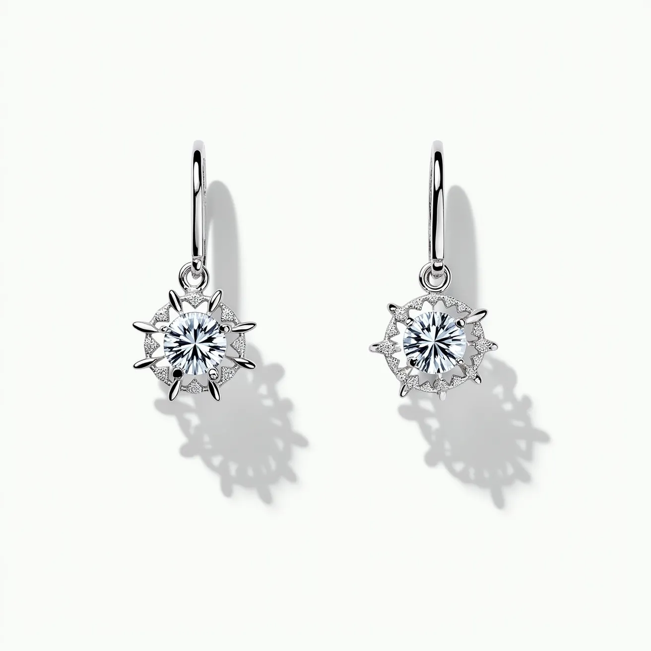 These white sapphire earrings feature a striking design with round-cut gemstones set in an intricate starburst setting. The sapphires are securely held by multi-prong settings, enhancing their brilliance and allowing maximum light exposure. The earrings are crafted from polished metal, likely white gold or platinum, contributing to their elegant appearance. They attach via a classic hook clasp, ensuring a secure and comfortable fit for the wearer. The combination of the stunning gemstones and elegant metalwork creates a timeless and sophisticated look.