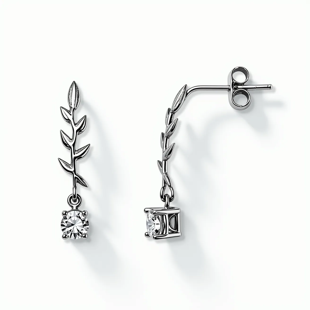 These white sapphire earrings feature a delicate design, incorporating a leaf motif crafted from a polished silver or white gold metal. The earrings showcase a round cut white sapphire at the end of the leaf chain, secured in a prong setting that enhances the brilliance of the gemstone. They are designed with a classic post back and butterfly clasp for secure attachment. The overall design combines elegance with nature-inspired elements, creating a sophisticated accessory.