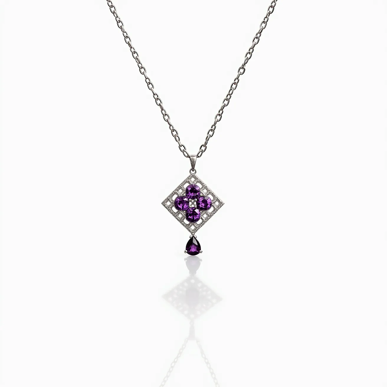 This alexandrite necklace features a delicate chain made of a metal that appears to be silver or white gold. The centerpiece of the necklace is an intricately designed pendant, showcasing a cluster of violet-hued alexandrite gemstones, which are likely precision-cut to enhance their natural brilliance. These stones are arranged in a symmetrical floral pattern, encased within a squared setting accented by smaller clear gemstones that add subtle sparkle. Below the central design, a single pear-shaped alexandrite gemstone dangles elegantly, further enhancing the pendant's sophisticated allure. The necklace is fastened with a standard clasp mechanism, ensuring it is both secure and easy to wear.