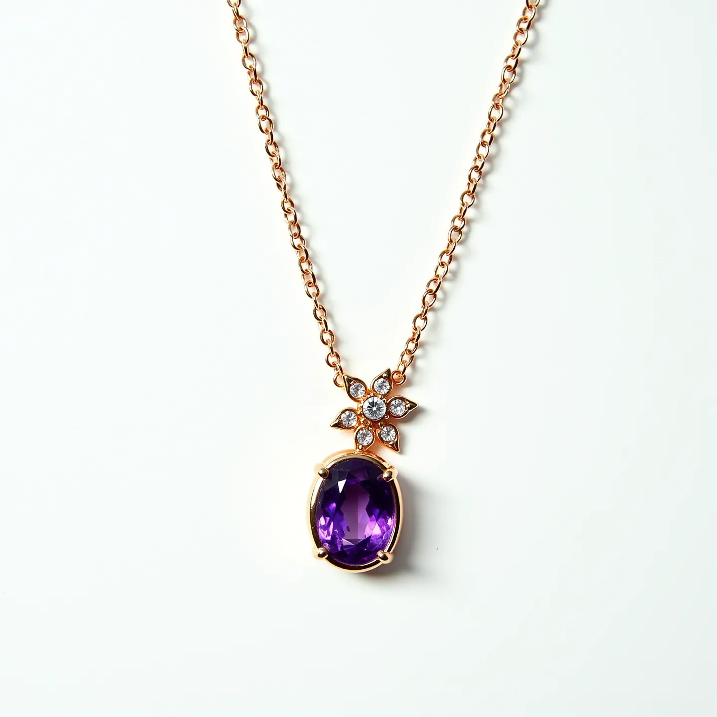 This amethyst necklace features a prominent oval-cut amethyst stone set elegantly in a gold bezel. The amethyst is complemented by a flower-shaped arrangement of small clear stones, likely diamonds, each held in a delicate prong setting. The pendant is suspended on a gold chain, combining simplicity with elegance. The necklace is equipped with a subtle gold clasp that ensures secure fastening while maintaining the overall refined design.