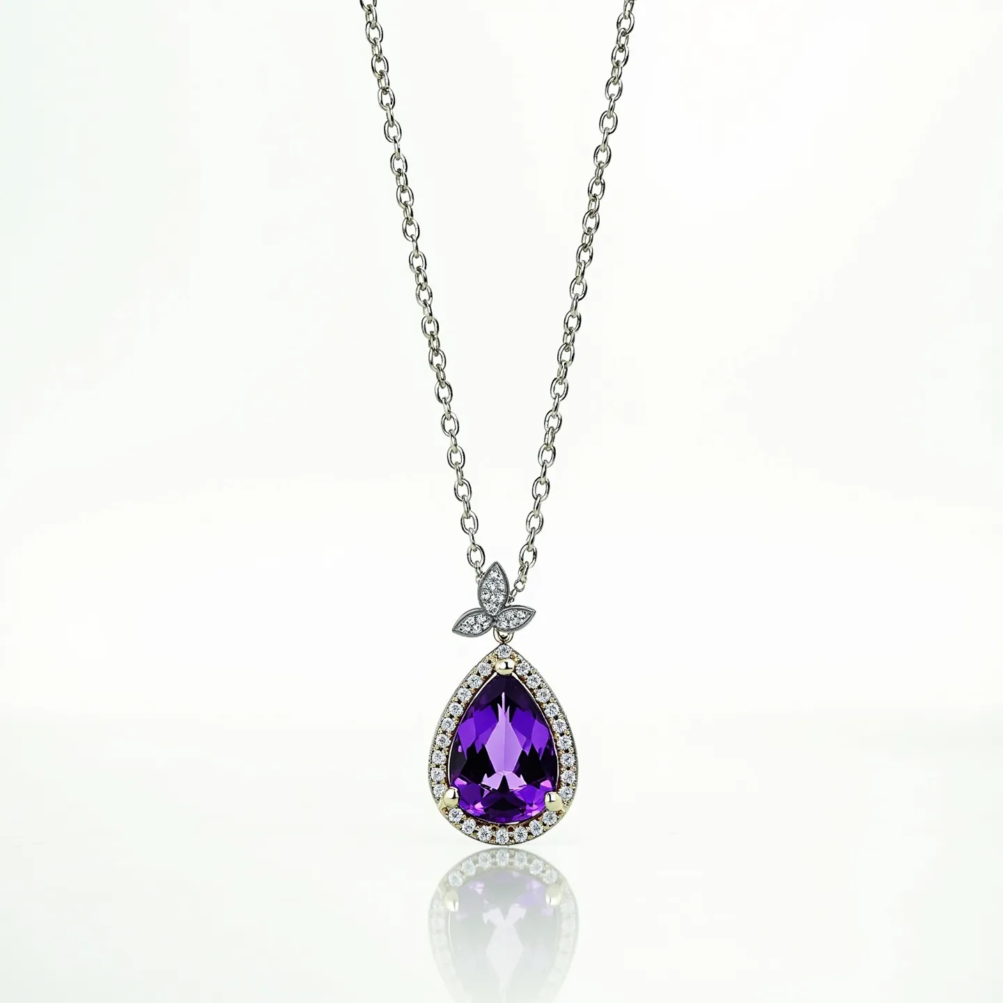 This amethyst necklace features a striking pear-shaped amethyst stone as the centerpiece, encircled by a halo of smaller clear gemstones, likely diamonds, set in a metal such as white gold or platinum. The amethyst showcases a deep purple hue, and its faceting enhances its brilliance and depth. The setting is further embellished with a floral motif above the main stone, adorned with additional small clear gemstones. The pendant hangs from a delicate chain that is crafted from a similar metal, emphasizing the elegance of the design. The necklace is secured with a standard clasp, ensuring both style and functionality.