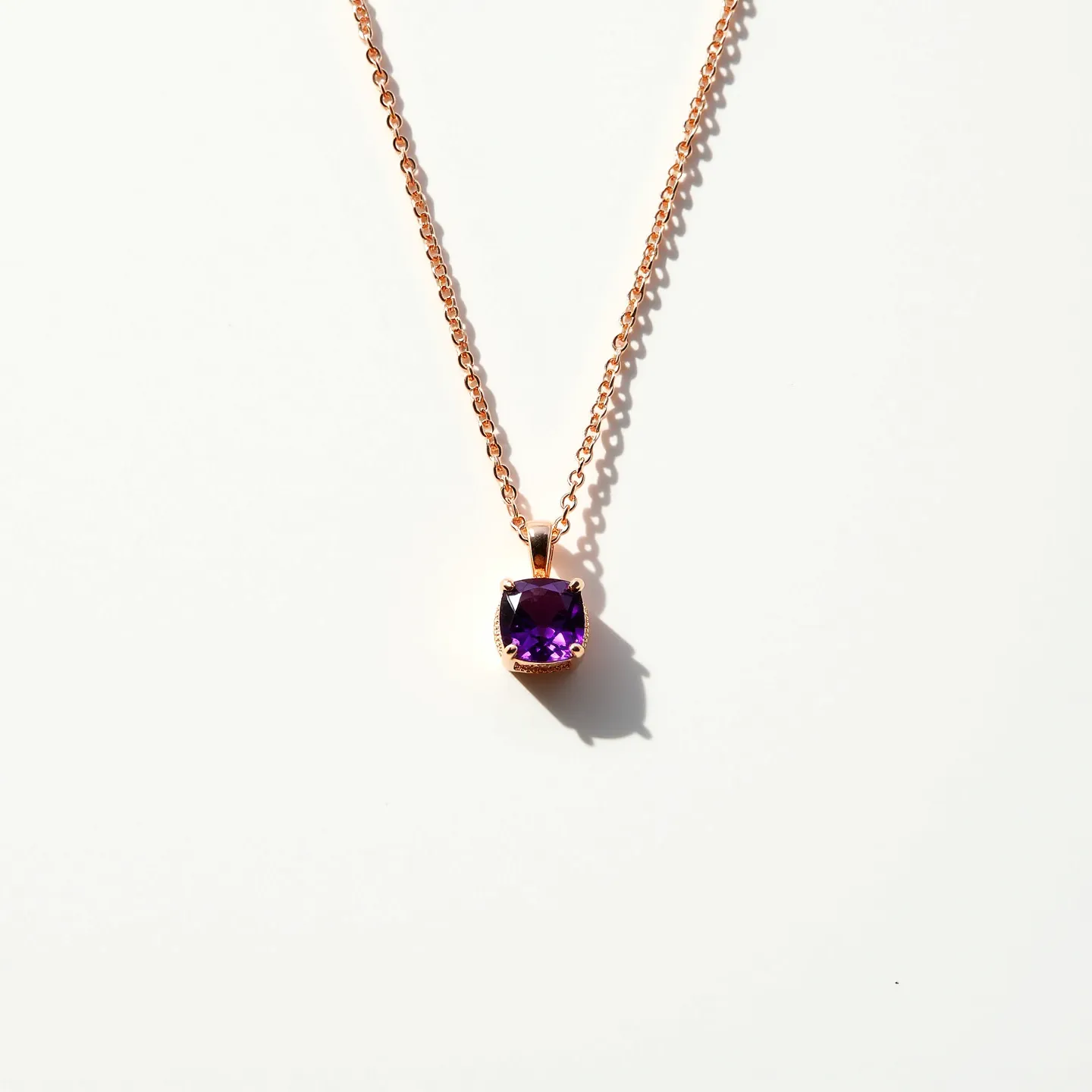 This amethyst necklace features a striking purple amethyst gemstone as its centerpiece, cut in a cushion shape to enhance its natural beauty. The stone is set in a prong setting, which securely holds the gem while allowing maximum exposure of the stone's facets to light. The chain appears to be made of a gold-toned metal, possibly gold or gold-plated, complementing the vibrant hue of the amethyst. The necklace is finished with a simple clasp, providing functionality and ease of wear. Overall, this necklace combines elegance with a touch of color, making it a versatile piece for various occasions.