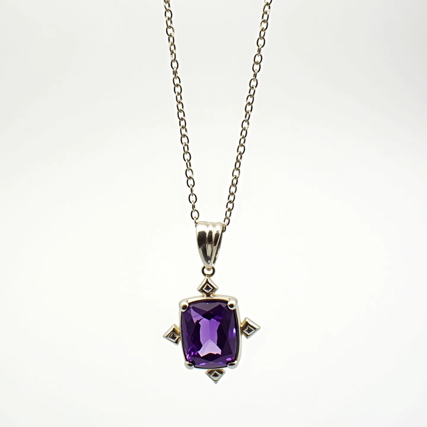 This amethyst necklace features a striking square-cut amethyst gemstone, showcasing a deep purple hue. The stone is set in a decorative silver setting with intricate designs extending outward, giving it a dynamic and elegant appearance. The pendant is attached to a fine silver chain, which is likely made of sterling silver, known for its durability and shine. A polished silver bail connects the pendant smoothly to the chain, providing both support and style. The necklace is fastened with a traditional clasp, ensuring secure wear.