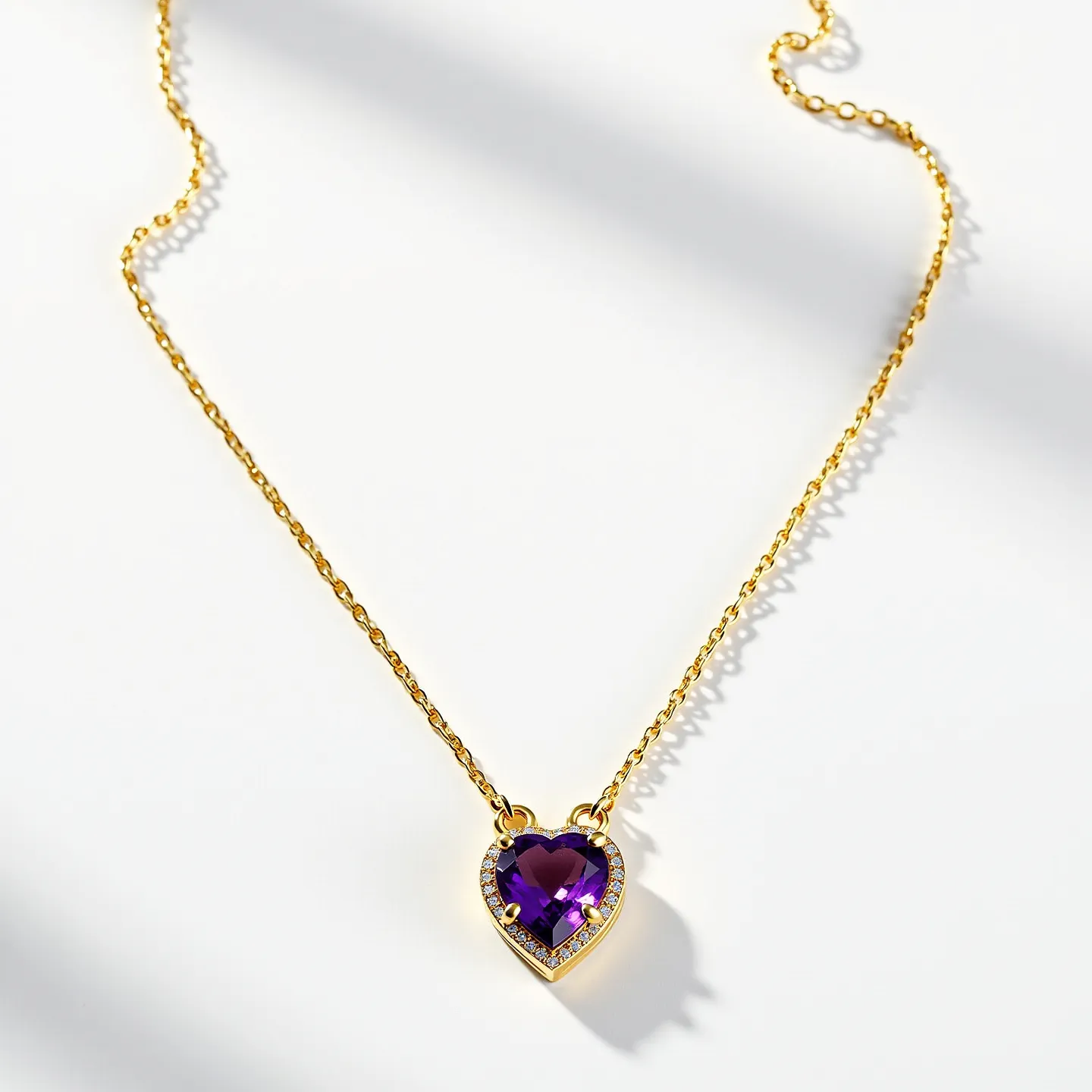 This amethyst necklace features a stunning heart-shaped amethyst gemstone as its focal point, elegantly set within a gold-toned chain. The amethyst is faceted to enhance its natural beauty and brilliance, surrounded by a delicate border of smaller, sparkling stones, possibly diamonds or cubic zirconia, enhancing its overall allure. The setting appears to be secured with metal prongs that complement the hue and design of the necklace. The chain is composed of finely linked gold-toned metal, offering a classic and sophisticated appearance. The necklace is likely equipped with a standard clasp mechanism for secure attachment, ensuring ease of wear and durability.