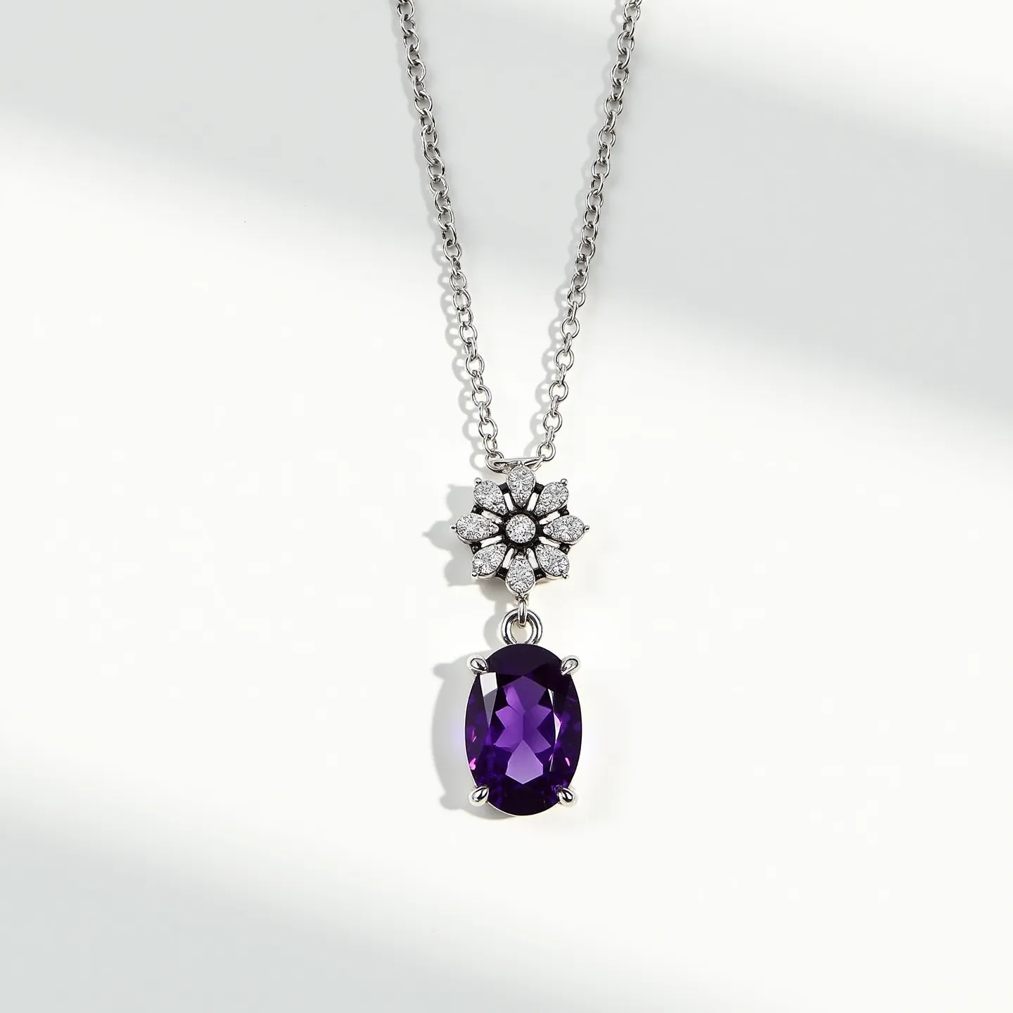 This amethyst necklace features an elegant chain crafted from a shiny metal, likely silver or white gold. The centerpiece of the necklace is a large, oval-cut amethyst gemstone, held securely in a prong setting that allows for maximum light reflection to enhance its deep purple hue. Above the amethyst hangs a floral motif encrusted with small, round-cut diamonds, adding a sparkling contrast and highlighting the luxurious nature of the piece. The necklace likely includes a standard clasp, typical of fine jewelry, ensuring it can be worn securely and comfortably.