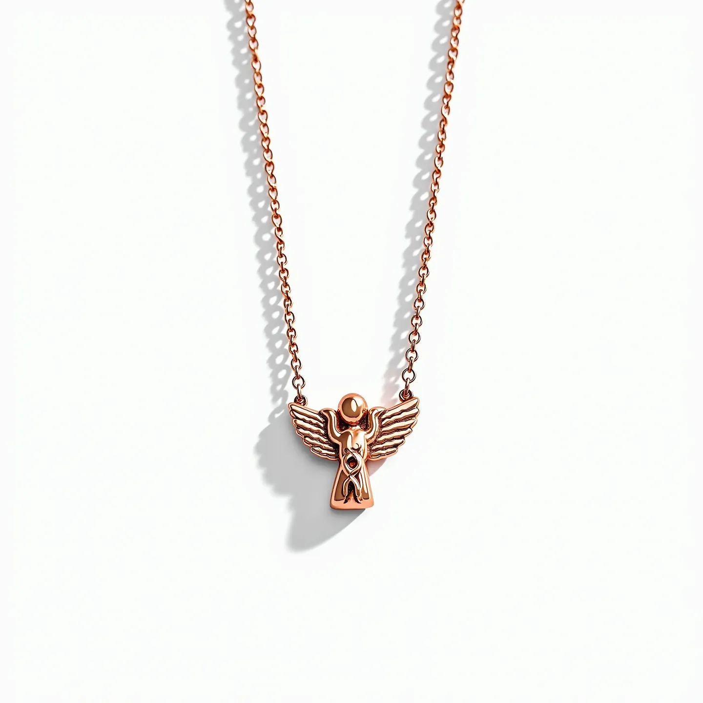 This angel necklace features a beautifully crafted angel pendant in a rose gold metal finish. The angel design incorporates sleek, stylized wings and a polished surface for an elegant look. At the center of the pendant, there is a small, round gemstone, possibly a diamond, set in a simple bezel setting, adding a subtle sparkle. The necklace is attached to a delicate chain of matching rose gold hue, featuring interlocking oval links that provide a secure and stylish connection. The clasp mechanism is not visible, but it likely employs a standard clasp for ease of wear.