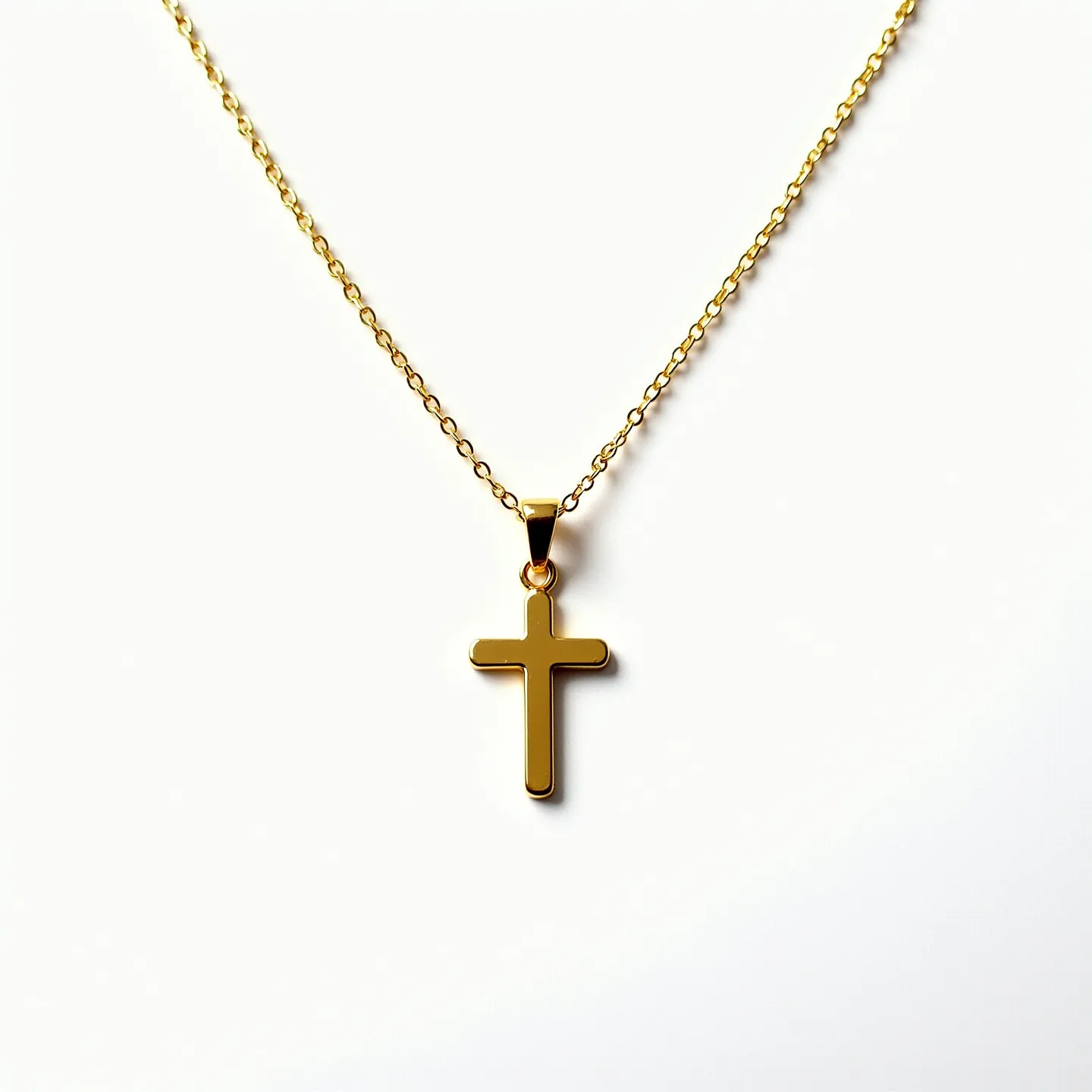 This baby cross necklace features a delicate gold-toned cross pendant that hangs from a fine chain. The cross has a polished finish that gives it a simple yet elegant look. It appears to be made from metal, possibly gold-plated or another similar finish. The chain links are small and evenly crafted, adding to the necklace's delicate appearance. The pendant is attached to the chain with a small, streamlined bail that allows for smooth movement along the chain. The necklace is secured with a spring ring clasp, which provides a reliable and secure closure.