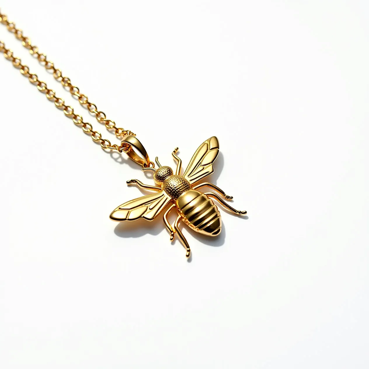 This bee necklace features a striking design with a gold-tone finish, giving it an elegant and polished appearance. The bee pendant is intricately detailed, showing textured areas on the wings and body to mimic a real bee's anatomy. The pendant is attached to a thin chain that complements the gold color of the bee, creating a cohesive look. The necklace likely features a simple clasp mechanism, such as a lobster clasp, providing both security and ease of wear. The piece does not incorporate any visible gemstones, focusing instead on the metallic allure and the intricate craftsmanship of the bee motif.