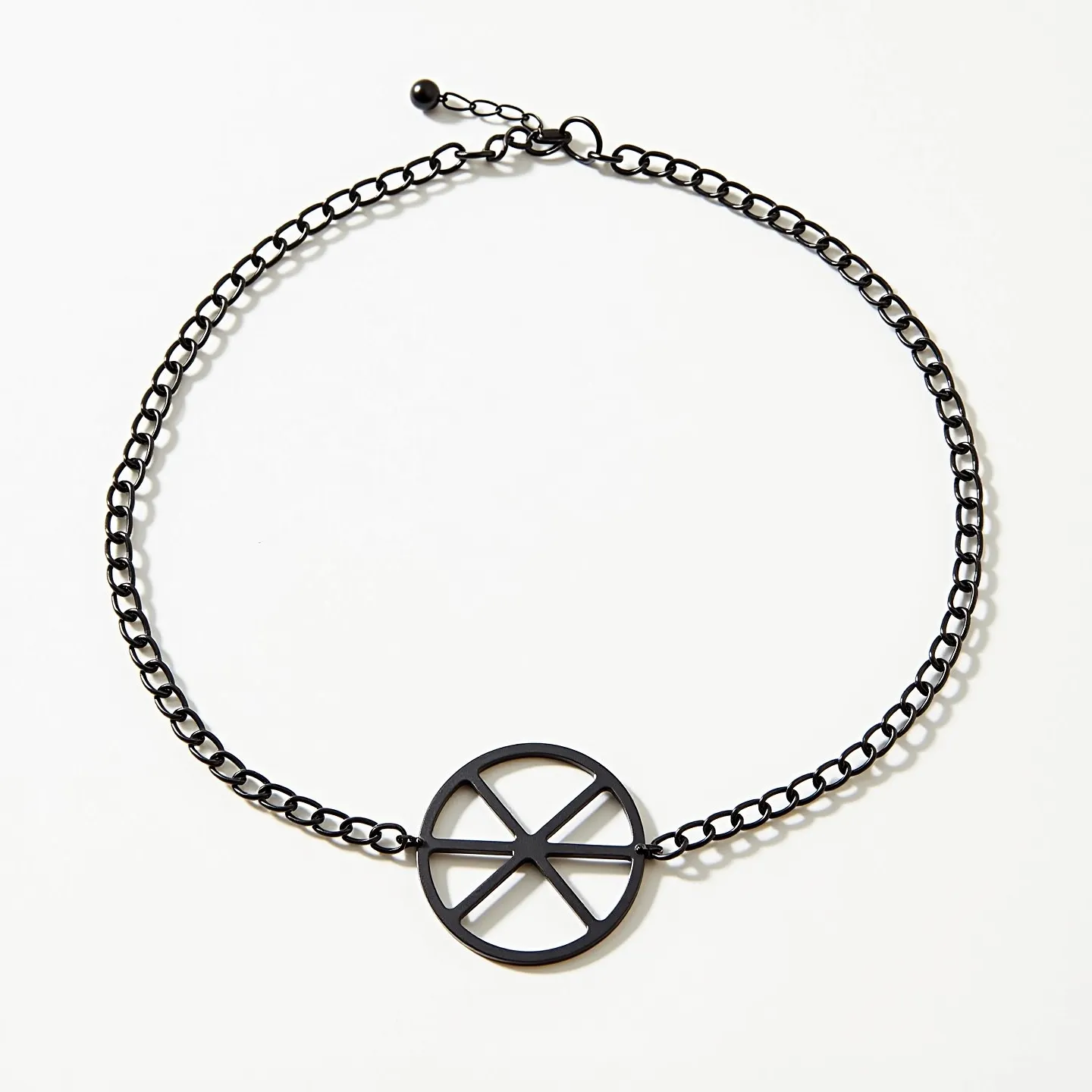 This black choker features a simple yet striking design with a primarily metal construction. The chain consists of medium-sized links, giving it a sturdy yet elegant appearance. At the center of the choker, there is a geometric circular pendant with intersecting lines creating a distinct pattern. The choker is equipped with an adjustable clasp, allowing for easy wearability and customization of fit, which is complemented by a small, rounded bead at the end for additional security. The dark, matte finish of the choker adds a modern and versatile element to its overall aesthetic.