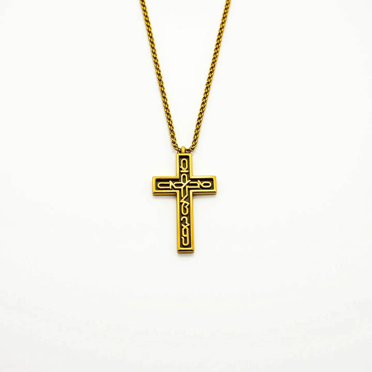 This boys cross necklace features a striking gold-toned metal pendant intricately designed with a black enamel inlay, forming a detailed pattern within the cross itself. The cross is suspended from a matching gold-toned chain, which appears to be composed of a tightly interwoven link style, ensuring durability and a classic appearance. Notably, the cross does not showcase any gems or stones, focusing instead on the contrast between the metal and the enamel. The attachment of the pendant to the chain is accomplished through a simple, yet secure, loop at the top of the cross, allowing it to hang evenly. This necklace combines elegant design elements, making it a meaningful and stylish piece.