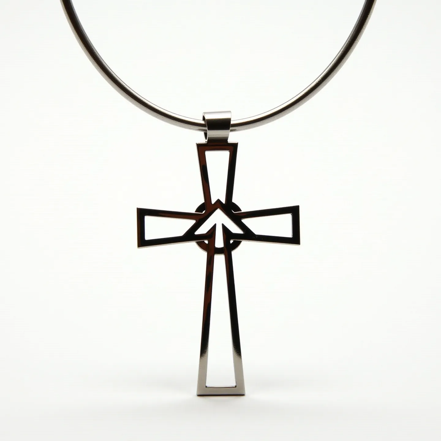 This boy's cross necklace features a sleek, modern design crafted from polished metal, likely stainless steel or silver, giving it a reflective, shiny appearance. The cross itself is composed of open, angular lines, creating a minimalist and geometric pattern that is both contemporary and elegant. It hangs from a smooth, sturdy metal band, suggesting the possibility of a secure clasp at the back for ease of wear. The cross does not incorporate any gemstones or additional embellishments, keeping the focus on its clean and stylish architectural form.