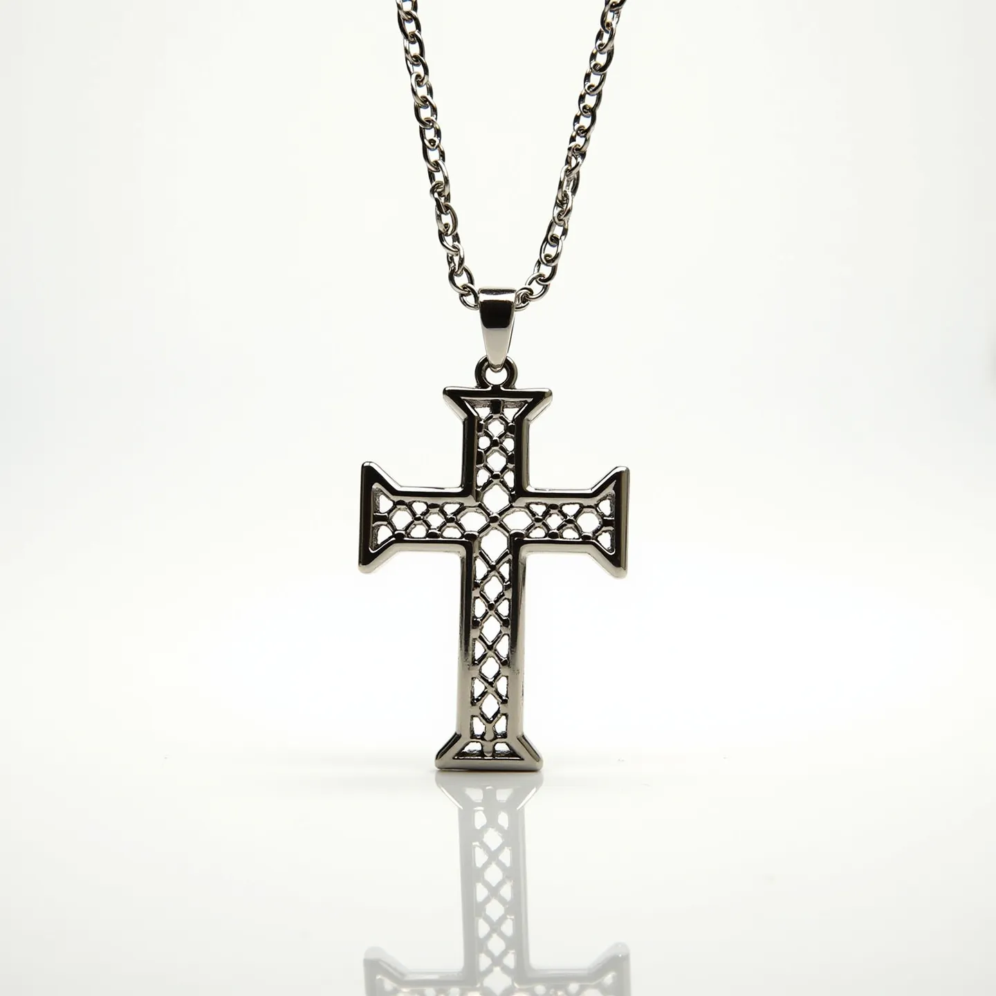 This boy's cross necklace features a polished metal cross pendant with an open lattice design, giving it an airy and modern look. The intricate pattern within the cross adds a touch of elegance, while the sleek metal edges provide a sophisticated finish. The pendant is suspended from a sturdy, matching metal chain, which has a consistent, smooth design, offering both durability and style. The chain is equipped with a standard clasp, ensuring the necklace stays securely fastened when worn. Overall, the simplicity and detail of this cross necklace make it a versatile accessory suitable for various occasions.