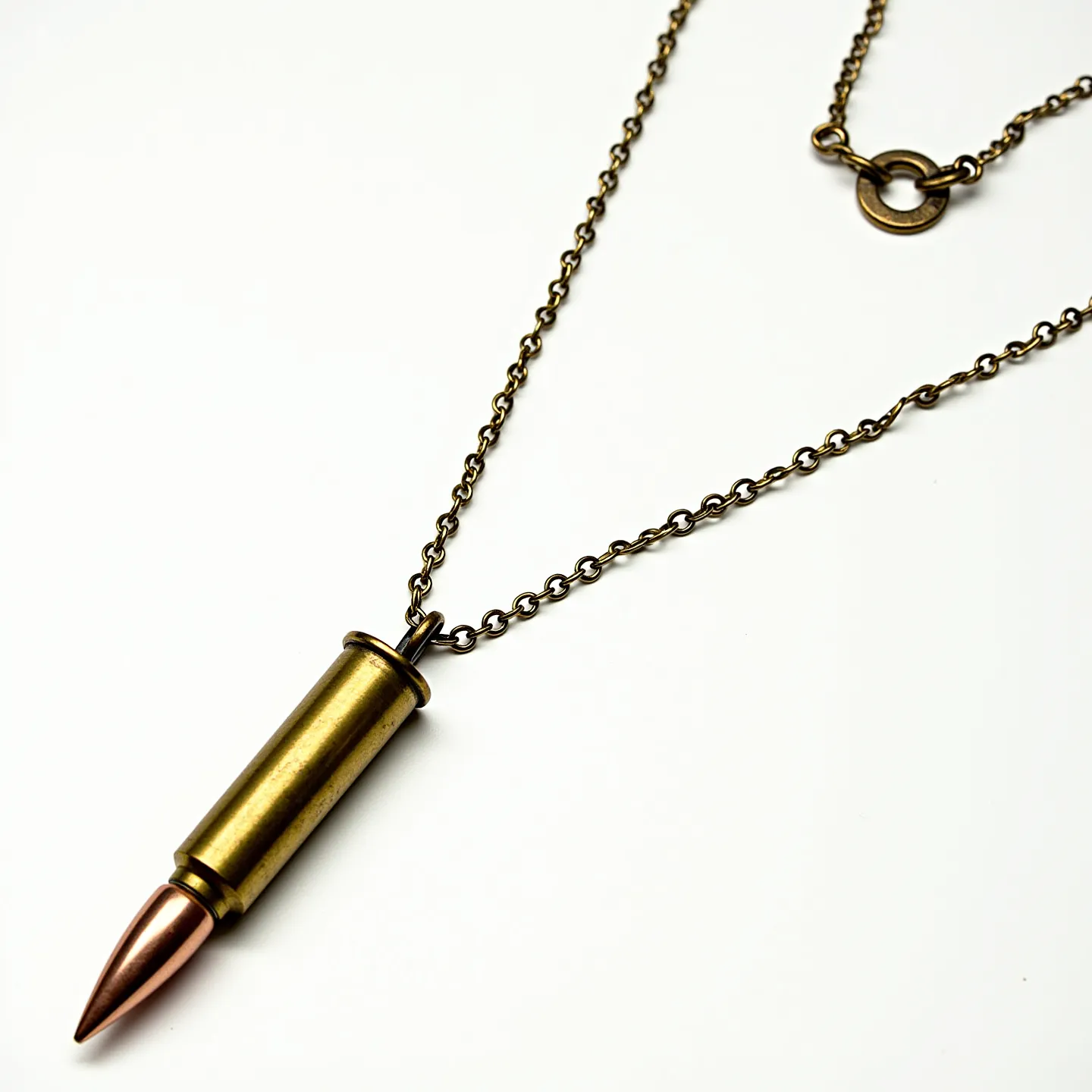 This bullet necklace features a detailed replica of a bullet with a brass-colored casing and a copper-toned tip, showcasing a realistic metallic finish. The pendant is suspended from a matching brass-colored chain, providing a cohesive and rugged aesthetic. The chain is joined by a toggle clasp, adding both style and functionality, allowing for easy fastening. The design utilizes sturdy materials that enhance the necklace’s durability and industrial charm, making it a striking and bold accessory.