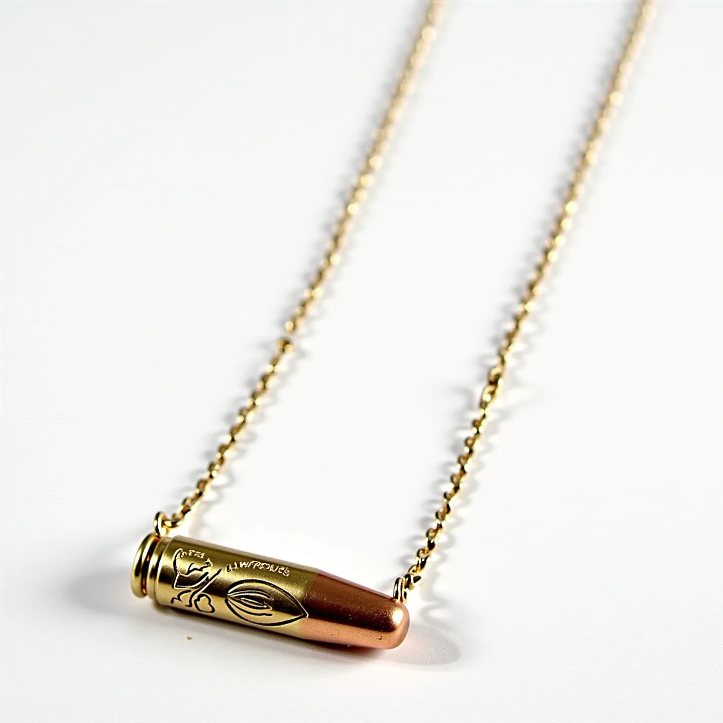 This bullet necklace features a sleek design with the bullet component crafted from a metallic material that appears to be brass or brass-toned. The bullet is elegantly suspended on a delicate chain that exhibits a shiny, golden finish, complementing the bullet's color. The bullet itself is engraved with intricate patterns and text, adding a touch of detail and craftsmanship to its appearance. The chain likely fastens with a simple clasp for easy wearing, completing the necklace's practical yet stylish design.