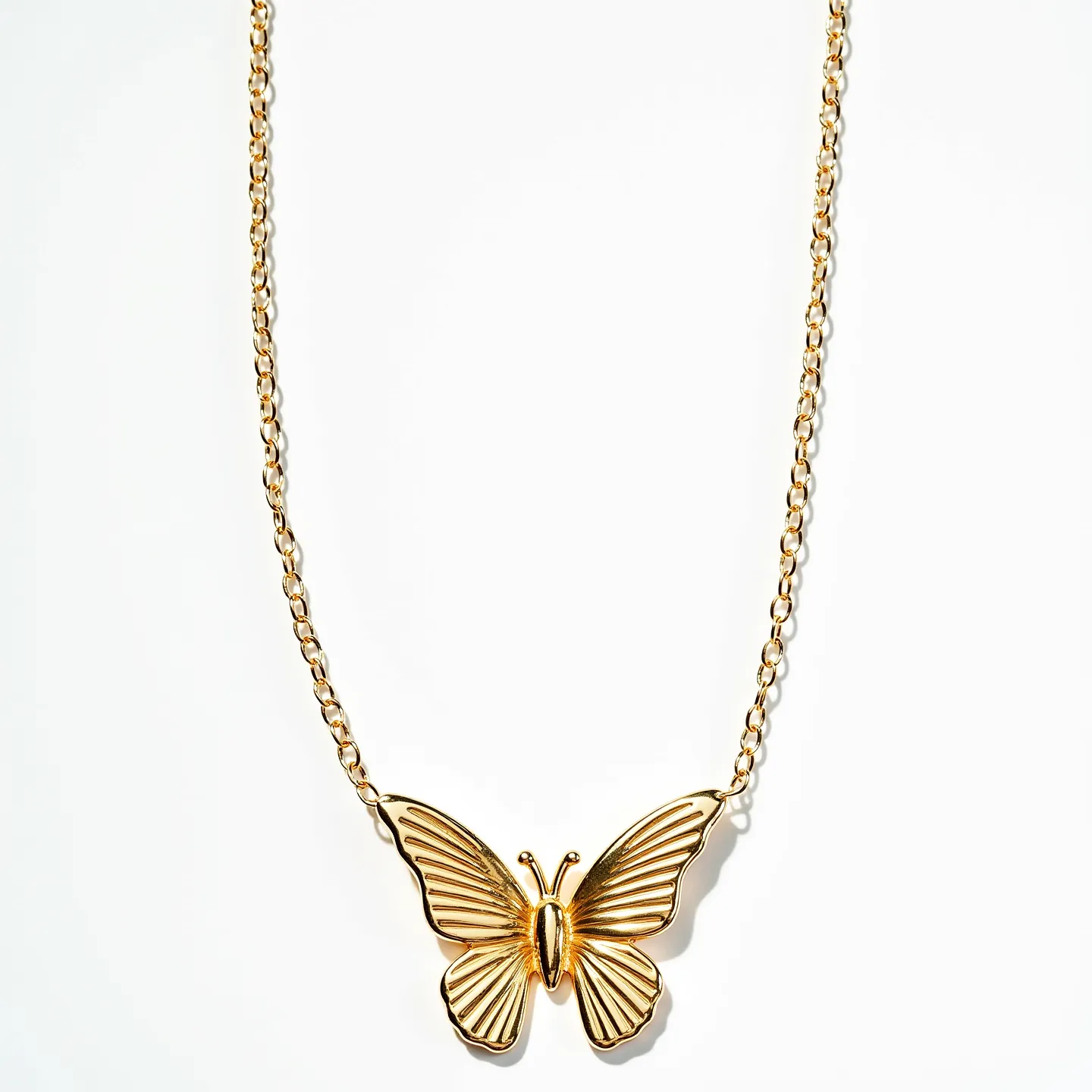 This butterfly necklace features an elegant and detailed butterfly pendant, crafted from a shiny, gold-colored metal that gives a luxurious and refined appearance. The butterfly wings are intricately textured, adding depth and character to the design. The necklace is attached to a delicate chain that complements the pendant’s style without overshadowing it, creating a harmonious balance. The chain likely has a standard clasp mechanism, ensuring easy wearability and security. The minimalist design emphasizes the beauty of the butterfly form, making it a versatile accessory suitable for various occasions.