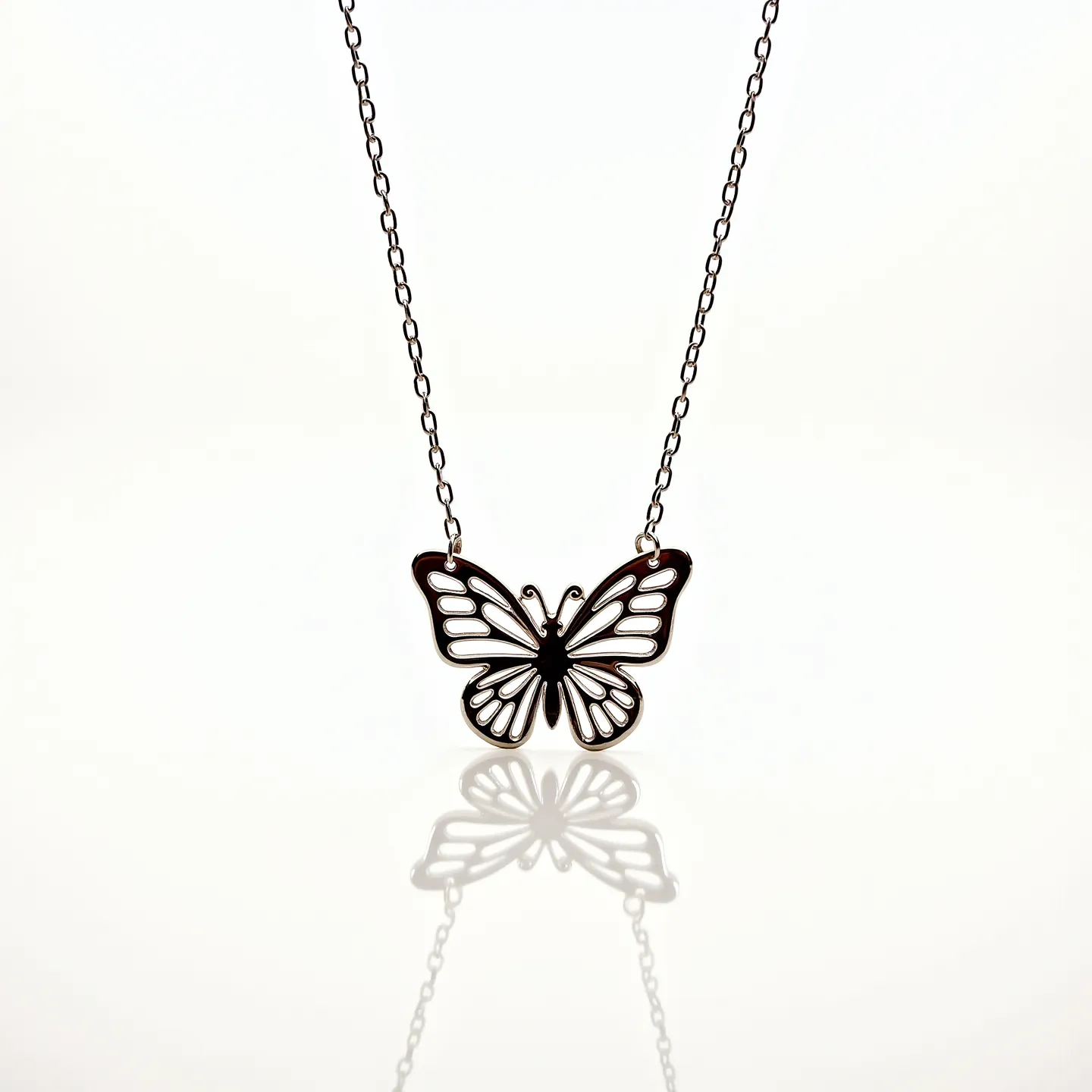 This butterfly necklace features a delicate silhouette of a butterfly crafted in metal, showcasing an intricate openwork design. The pendant, suspended on a fine chain, exhibits a minimalist style without the inclusion of gemstones. The chain appears to be made from a matching metal material that complements the pendant's finish. The piece is completed with a standard clasp, likely a lobster or spring ring clasp, allowing for secure and easy wearability. The overall design emphasizes simplicity and elegance, making it a versatile accessory for various outfits.